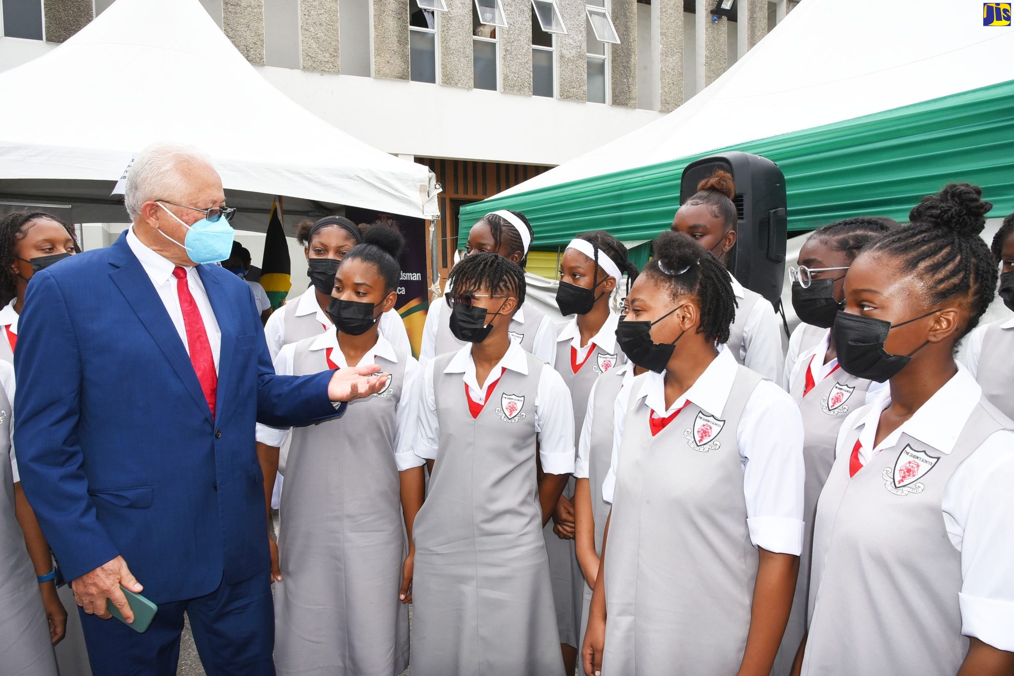 Minister of Justice, Hon. Delroy Chuck (left), engages students of The Queen’s School, during the National Public Education Day Symposium, staged at 144 Maxfield Avenue, in St. Andrew, on June 16.