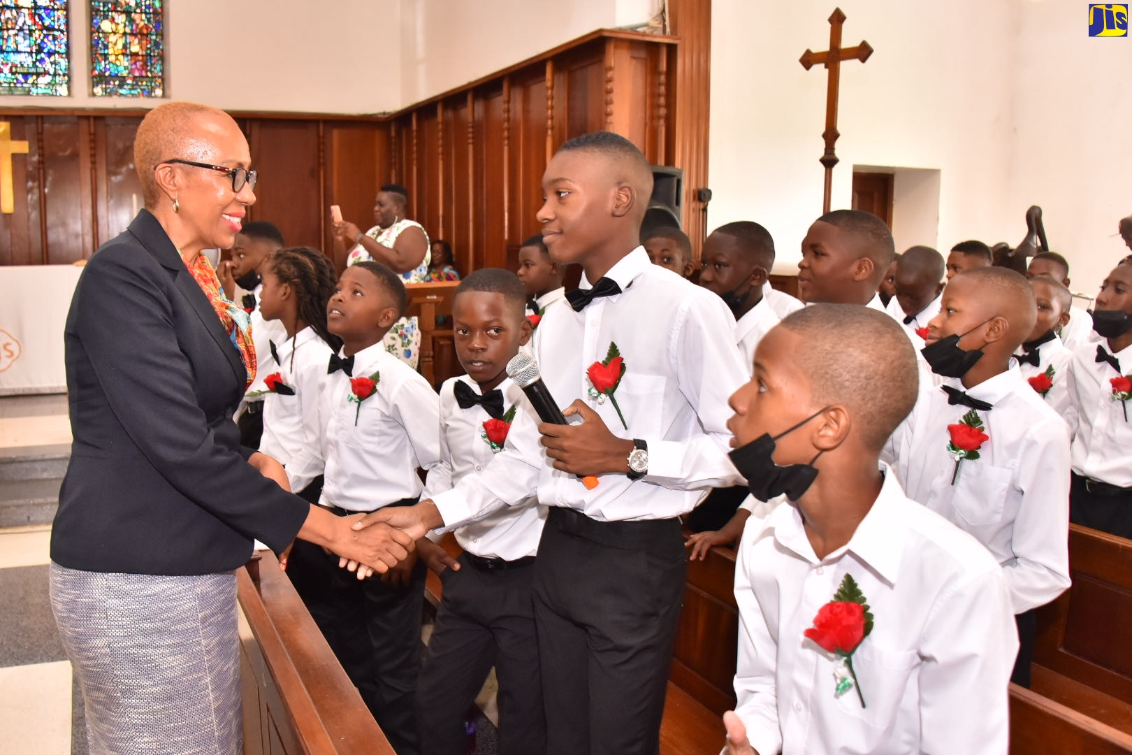 Minister of Education and Youth, Hon. Faval Williams (left), greets students at the Hope Valley Experimental School graduation exercise, held at the University Chapel in St. Andrew on June 29.