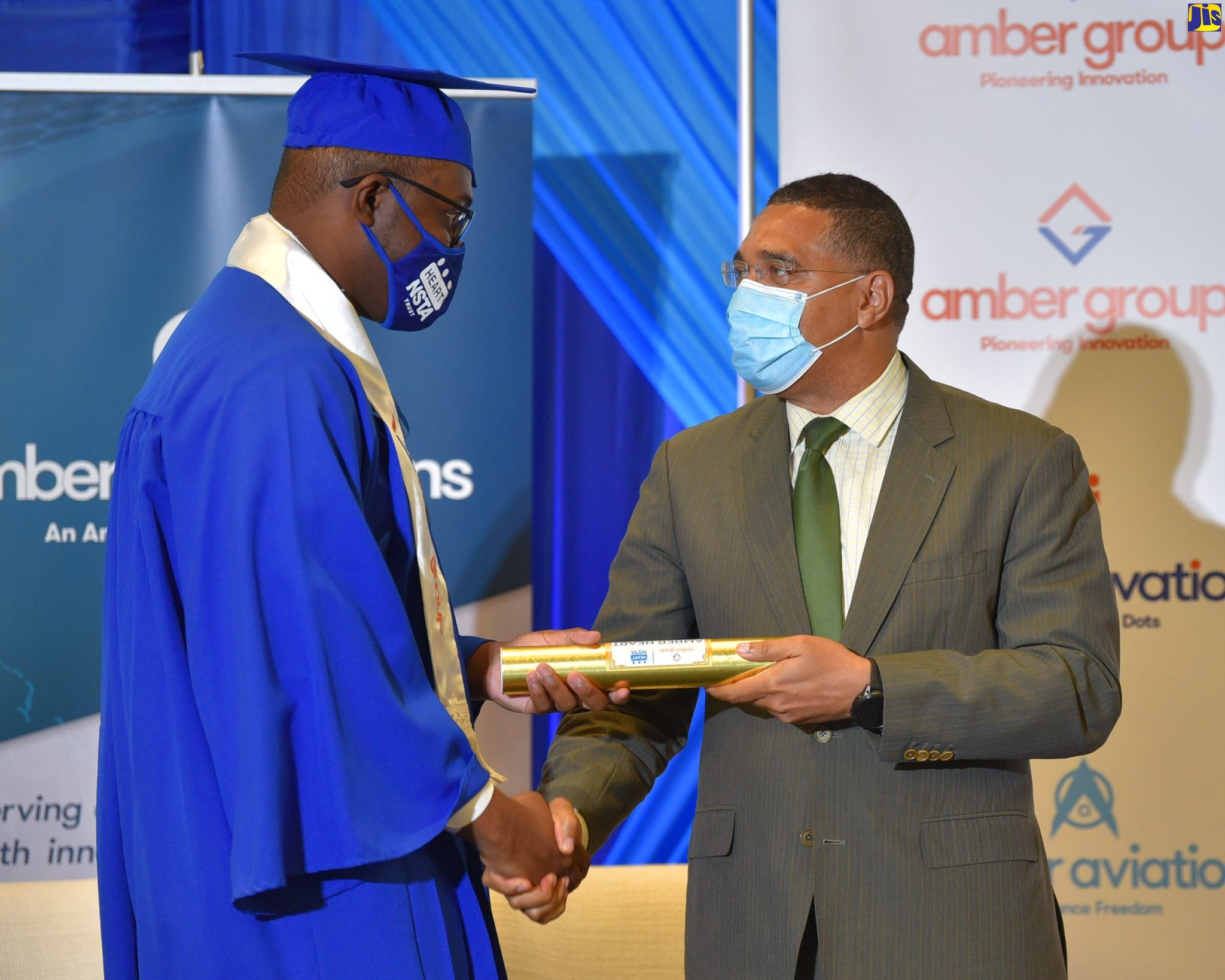 Prime Minister, the Most Hon. Andrew Holness (right), presents a certificate to  Akeem Henry, who was the valedictorian at the Amber HEART Academy’s graduation ceremony held at the AC Hotel by Marriott Kingston in St. Andrew on June 1. 