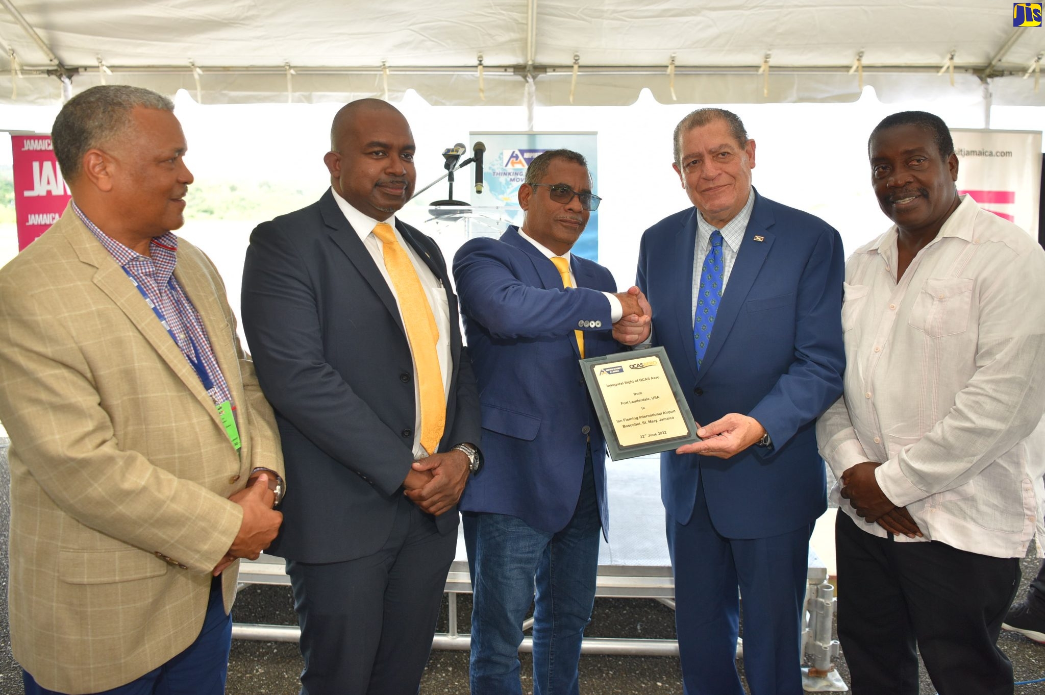 Minister of Transport and Mining, Hon. Audley Shaw (second right), and President, Quality Corporate Aircraft Services (QCAS) Aero, Ronald Sammy (third left), display the commemorative plaque for the inaugural flight by Quality Corporate Aircraft Services (QCAS) Aero, out of Fort Lauderdale to the Ian Fleming International Airport in St. Mary on Wednesday (June 22). Also pictured are (from left) President, Airports Authority of Jamaica (AAJ), Audley Deidrick; Director of Business Development,  QCAS Aero, Andrew Nicholson; and Member of Parliament, St. Mary Western, Robert Montague. 