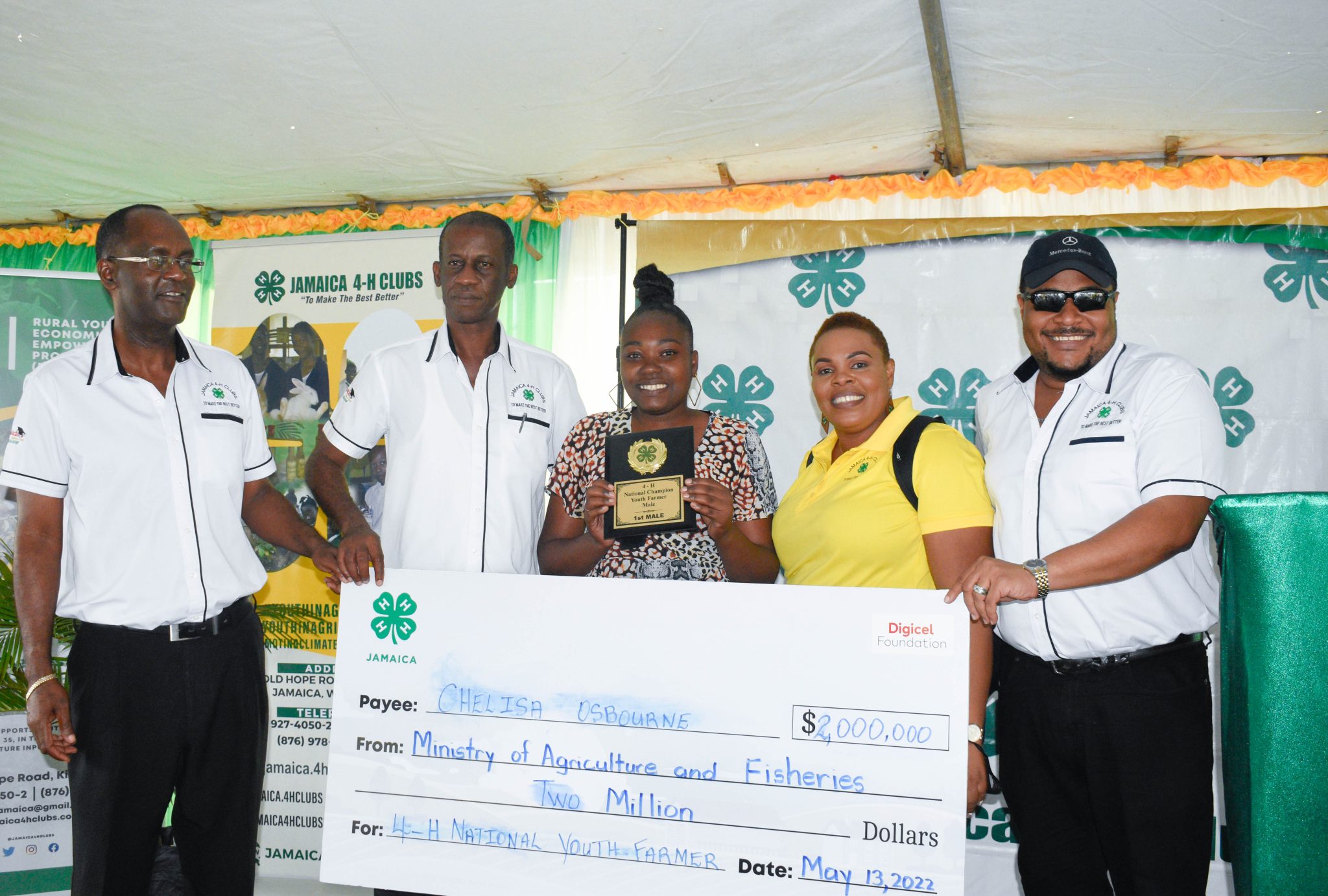 The Jamaica 4-H Clubs National Female Youth Farmer, Chelisa Osbourne (third left), shows off her trophy and cash prize at the recently held 4-H National Achievement Expo at the Denbigh Showground in Clarendon. Others pictured (from left) are Executive Director of the Jamaica 4-H Clubs, Dr. Ronald Blake; 4-H Clubs Parish Manager for Trelawny, Natanish Hines; and Chairman of the organisation, Collin Virgo.