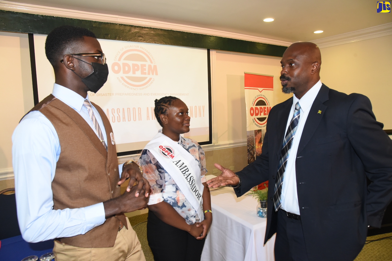 Director General at the Office of Disaster Preparedness and Emergency Management (ODPEM), Richard Thompson (right), shares a moment with the 2022 ODPEM Youth Ambassadors (from left) Cornwall College’s Curtis Clennon and Ardenne High’s Lianna Jones. Occasion was a sashing ceremony held at The Courtleigh Hotel on Tuesday, May 31.