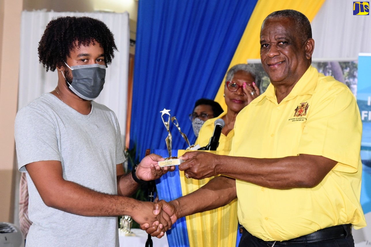 State Minister in the Ministry of Agriculture and Fisheries, Hon. Franklin Witter (right), presents an award to young fisher, Trey Williams of Old Harbour, on International Fisherman’s Day 2022. An event to commemorate the occasion was held at the Wembley Centre of Excellence in Hayes, Clarendon, on Wednesday (June 29).