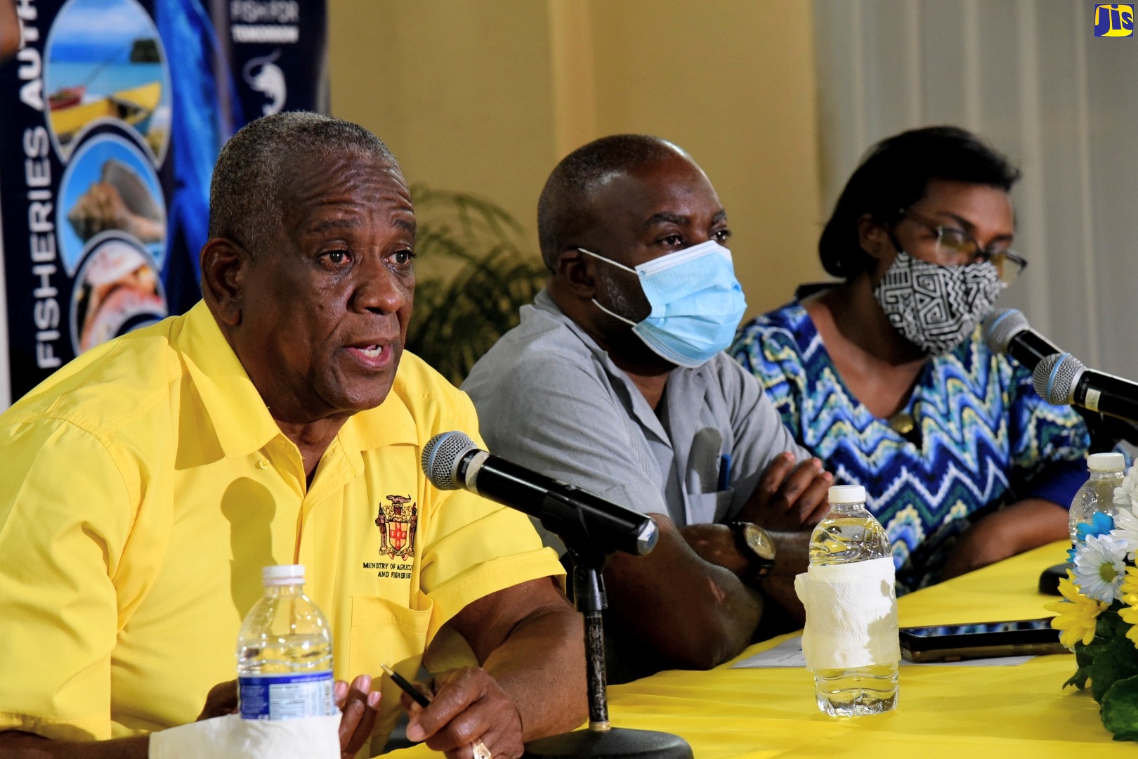 State Minister in the Ministry of Agriculture and Fisheries, Hon. Franklin Witter (left), addresses fishers at an International Fisherman’s Day Conference on June 29, at the Wembley Centre of Excellence in Hayes, Clarendon. With the State Minister are Permanent Secretary, Dermon Spence  and Executive Director, Caribbean Coastal Area Management Foundation, Ingrid Parchment.