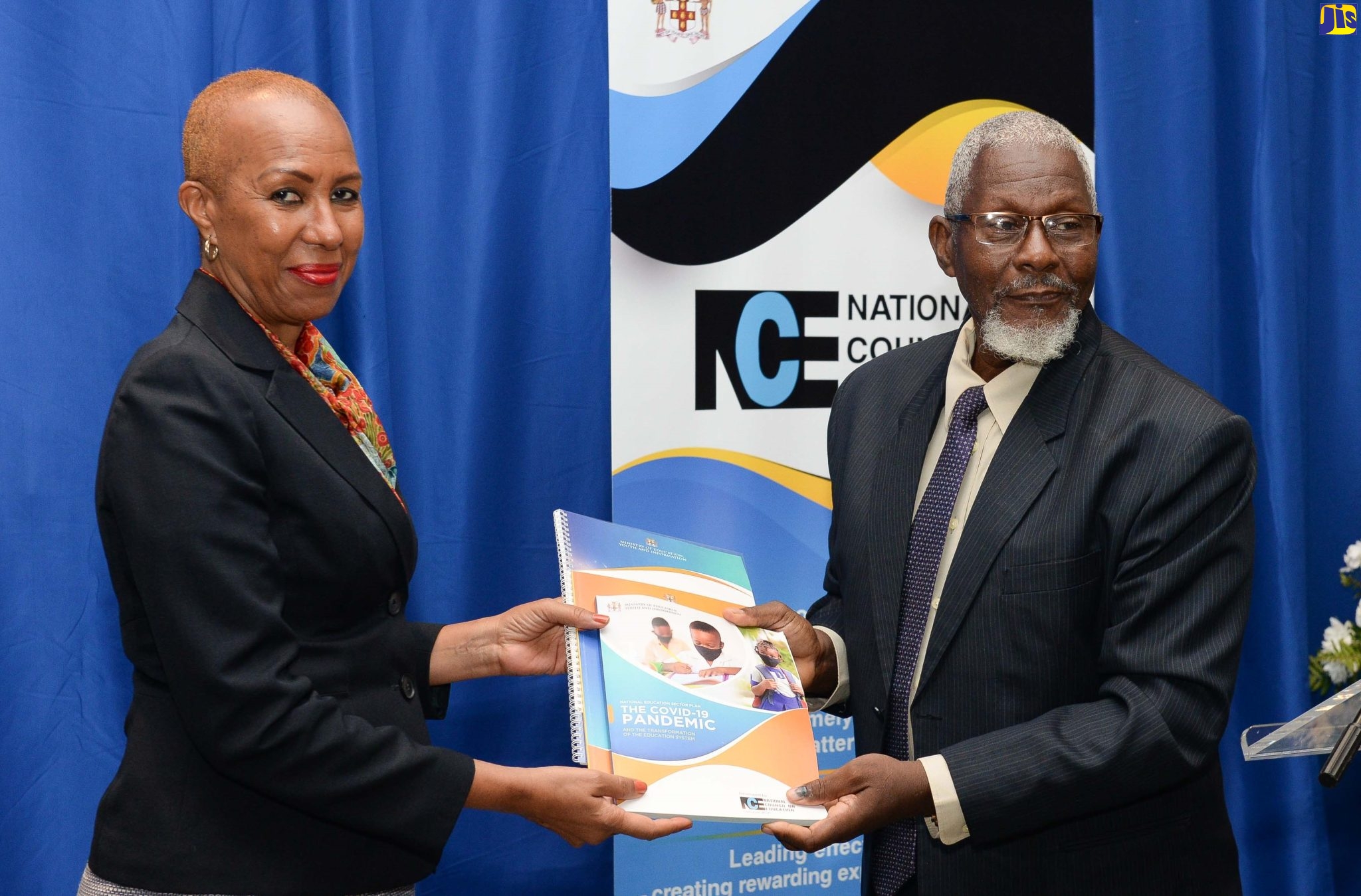 Minister of Education and Youth, Hon.  Fayval Williams (left), accepts a copy of the National Education Sector Plan from Council Member, National Council on Education (NCE), Professor Disraeli Hutton. Occasion was the final sitting of the current NCE, at the Jamaica Pegasus Hotel in New Kingston on Wednesday (June 29).