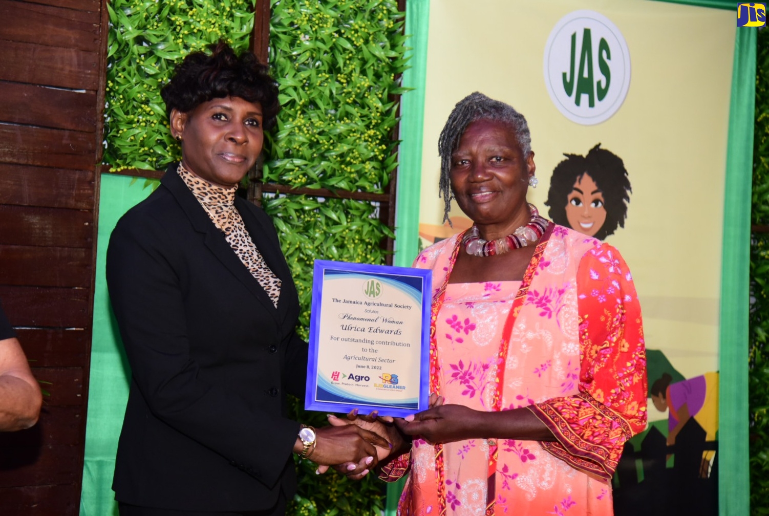 Ulrica Edwards (right) is named as one of 20 ‘Phenomenal Women in Agriculture’. Presenting her with the award is RJRGleaner Communications Group’s Joy Bennett.