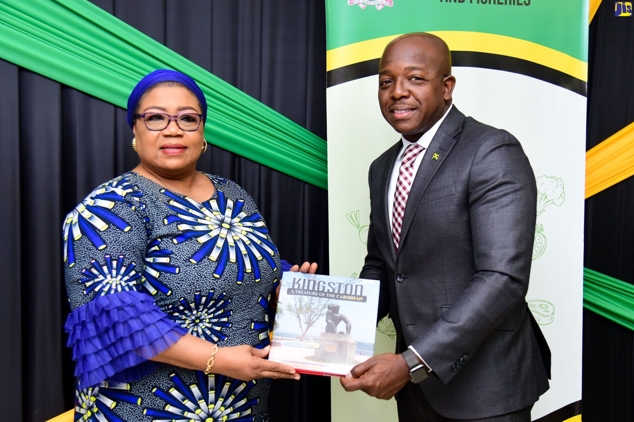 Minister of Agriculture and Fisheries, Hon. Pearnel Charles Jr., presents a publication, titled ‘Kingston: A Treasure of the Caribbean’, to High Commissioner of the Federal Republic of Nigeria to Jamaica, Her Excellency Dr. Maureen Piribonemi Tamuno, during the diplomat’s courtesy call at the Ministry’s offices, at Hope Gardens in St. Andrew, on Thursday (July 28).