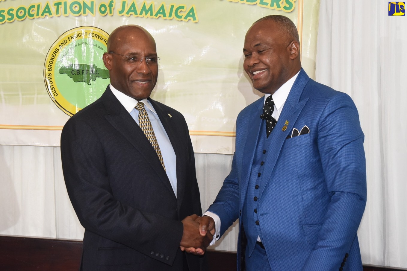 Minister of Industry, Investment and Commerce, Senator the Hon. Aubyn Hill (left), exchanges greetings with President, Customs Brokers and Freight Forwarders Association of Jamaica (CBFFAJ), Clive Coke, at the entity’s 56th Annual General Meeting held on Sunday (June 3), at The Jamaica Pegasus hotel, New Kingston.