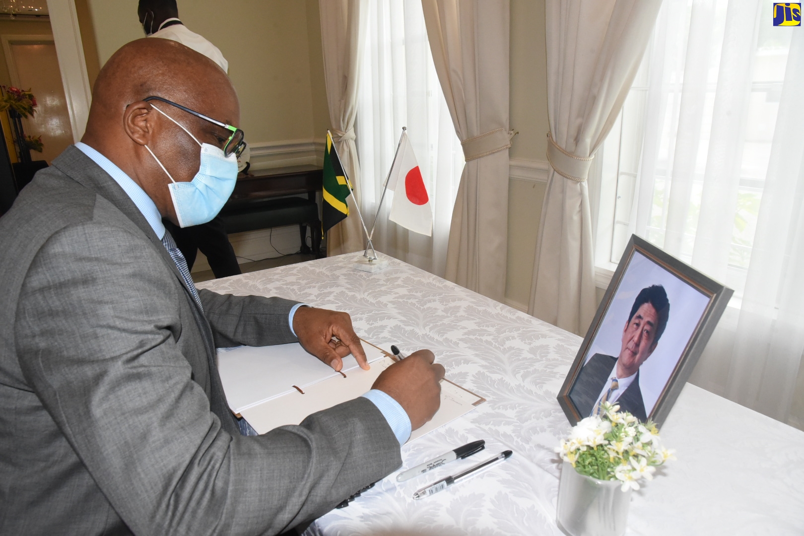 State Minister in the Ministry of Foreign Affairs and Foreign Trade, Senator the Hon. Leslie Campbell, signs the condolence book for former Prime Minister of Japan, Shinzo Abe, at the official residence of the Japanese Ambassador in St. Andrew on Tuesday (July 12).  The late former Prime Minister died on Friday (July 8) after being shot while giving a campaign speech in Nara, Japan.