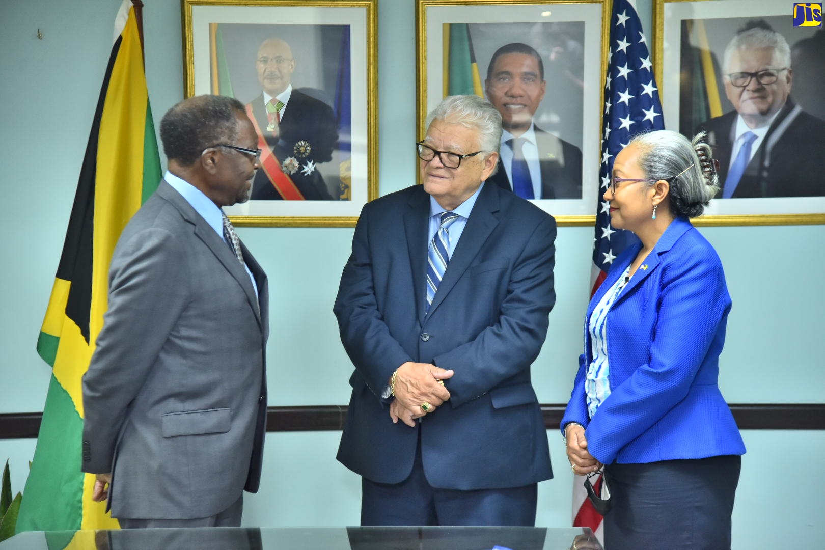 Minister of Labour and Social Security, Hon. Karl Samuda (centre), in discussion with United States (US) Ambassador to Jamaica, His Excellency Nick Perry, during the diplomat’s courtesy call at the Ministry’s offices on North Street in Kingston, on Thursday (July 28). Listening is Permanent Secretary in the Ministry, Colette Roberts Risden. Ambassador Perry also visited the Ministry’s Overseas Employment Centre on East Street in downtown Kingston.