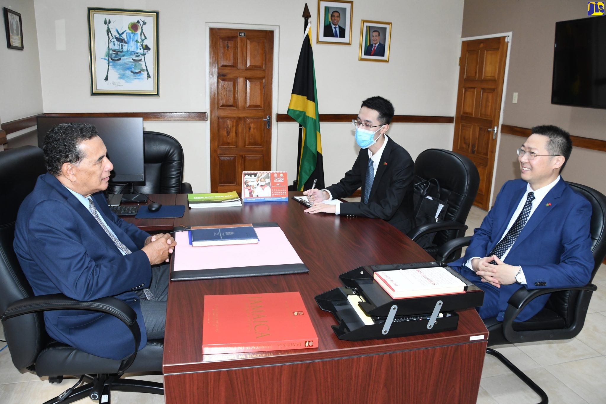 Minister of State in the Office of the Prime Minister, Hon. Homer Davis (left), holds discussions with newly appointed People’s Republic of China Ambassador to Jamaica, His Excellency Chen Daojiang (right), during a courtesy call at the Office of the Prime Minister - West in Montego Bay, St. James, on Friday (July 15). Listening is interpreter, Shiming Zhao.