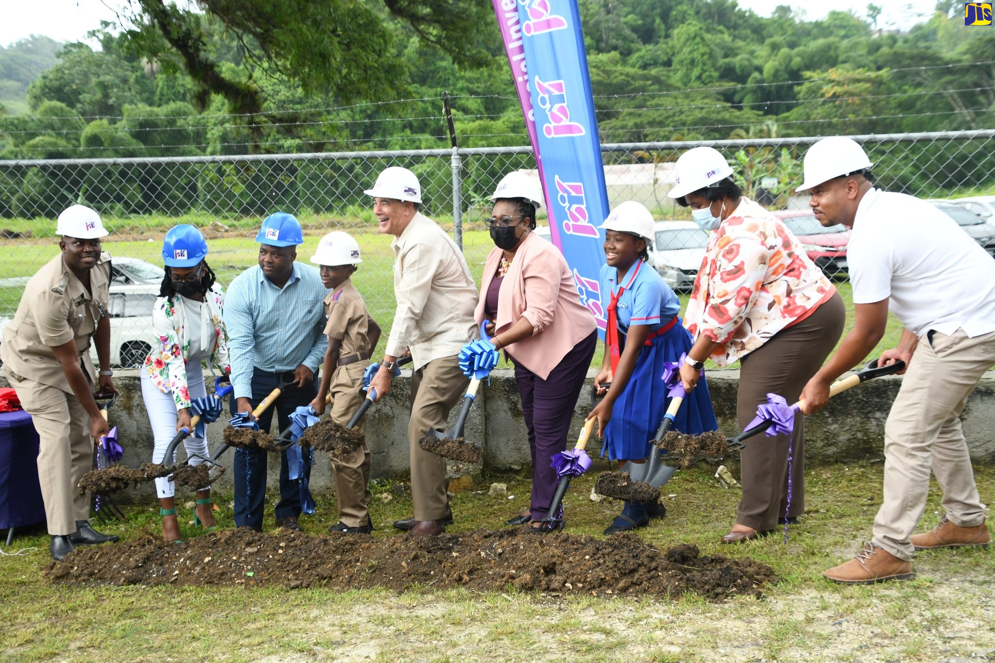 Minister of State in the Office of the Prime Minister, Hon. Homer Davis (fifth from left), breaks ground for the implementation of the Jamaica Social Investment Fund (JSIF) Safe Passage Project at the Roehampton Primary School in St. James on July 28. Also participating are (from left) Acting Commander of the St. James Police Division, Superintendent Carlos Russell; Board Chairperson at Roehampton Primary , Francine Lawrence; Principal of Roehampton Primary, Dane Julius; Head Boy at Roehampton Primary, Tyrese Clayton; Senior Manager of Social Development at JSIF, Mona Sue Ho; Head Girl at Roehampton Primary, Yahniel McIntyre; Regional Director at the Ministry of Education, Youth and Information – Region Four, Dr. Michelle Pinnock and Founder of Odell Allen Construction, Odell Allen.