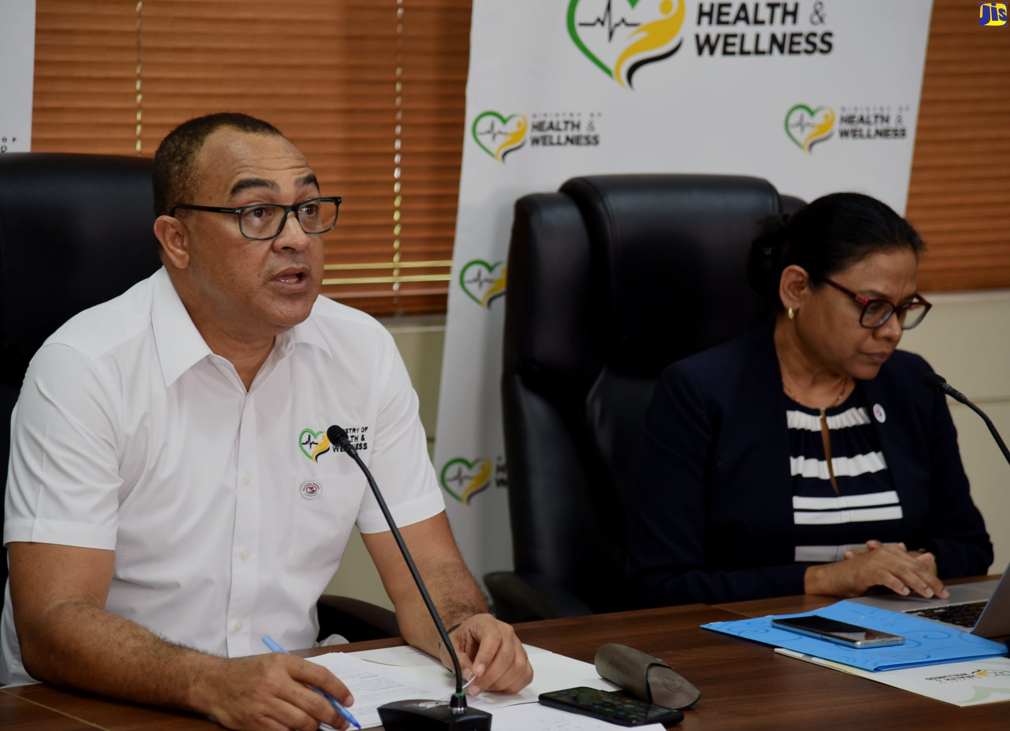 Minister of Health and Wellness, Dr. the Hon. Christopher Tufton, addressing a virtual press conference on Wednesday (July 6). At right is Chief Medical Officer, Dr. Jacquiline Bisasor-McKenzie