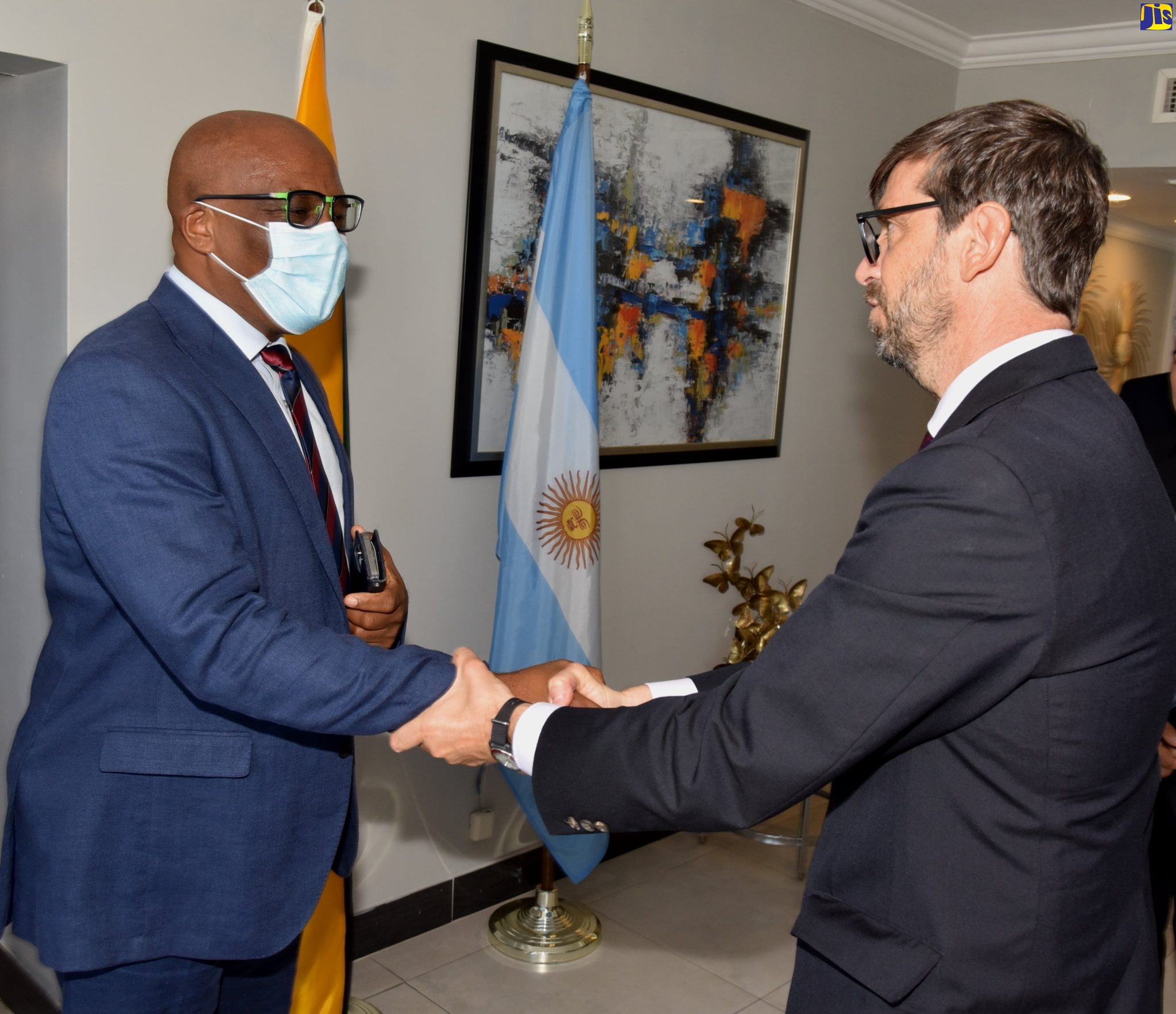 Minister of State in the Ministry of Foreign Affairs and Foreign Trade, Senator the Hon. Leslie Campbell (left) greets outgoing Ambassador of Argentina and Dean of the Diplomatic Corps, His Excellency Luis del Solar, at a farewell luncheon held at The Jamaica Pegasus hotel in New Kingston on July 14.