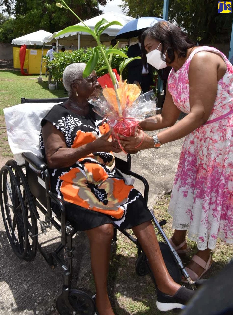 Wife of the Governor-General, Her Excellency, the Most Hon. Lady Allen (right) presents a gift to member of the Whitfield Town Church of God in Kingston, Inez Mowatt during the Leila May Dorman We Care Health Fair held at the church on Friday (July 1).