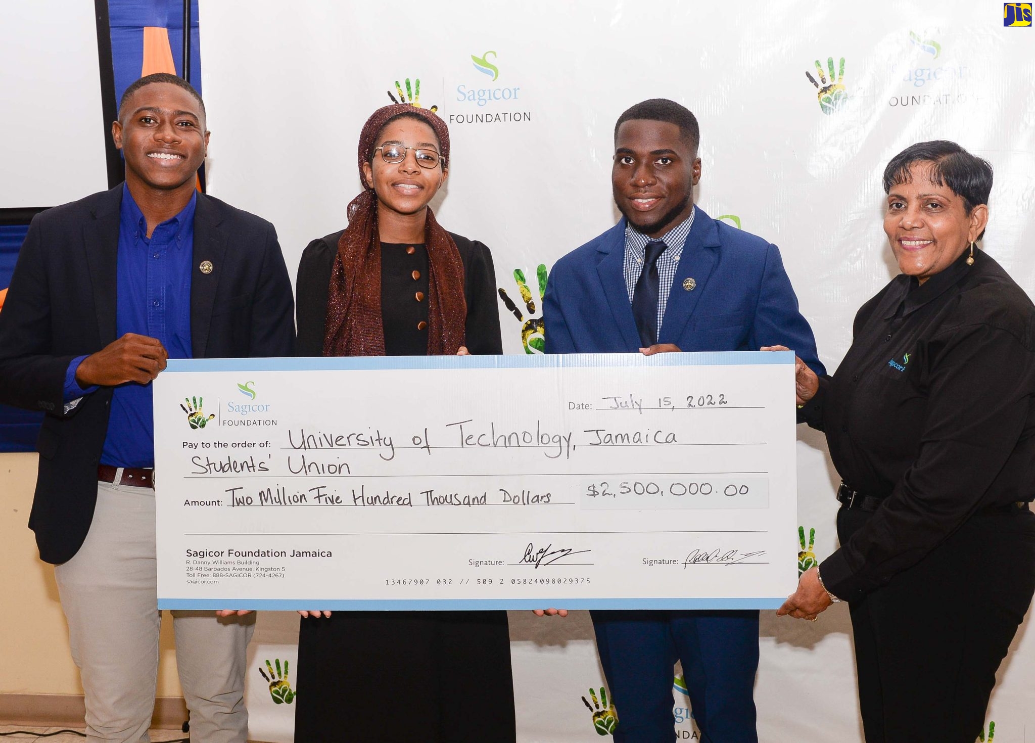 Branch Manager, Sagicor Hope Road, Claudette Ramdanie (right), assists in displaying the demonstration cheque in the value of $2.5 million, which represents sponsorship of this year’s Teach the Youth Programme by Sagicor Foundation. Others (from left) are: President of the Students Union Council Tavoy Barrett, volunteer representing HEART Trust/NSTA Ddjonaa Thomas; and Director of Community Services Avion Shaw. They were at the launch of this year’s Teach the Youth programme which is being hosted under the theme: ‘Bridging the Gap; Rebuilding the Future’.