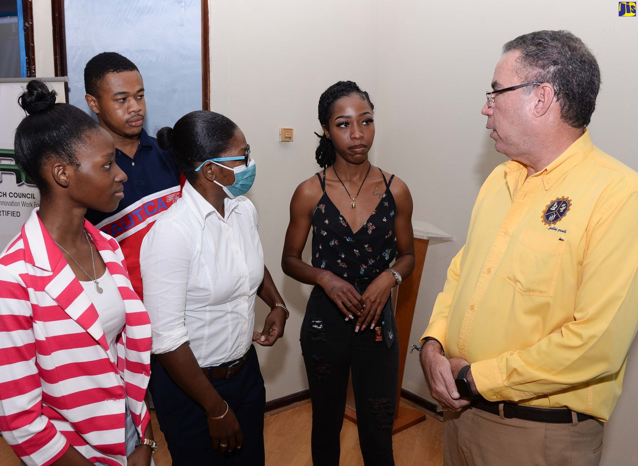 Minister of Science, Energy and Technology, Hon. Daryl Vaz (right), engages participants of the ‘Classroom to Real World’ science, technology, engineering and mathematics (STEM) mentorship workshop at the PCJ Auditorium in St. Andrew, on July 21. They are (from left): Jhoneil Anderson; Zakhele Ellington; Georgette Green and Alexandra Brown.
