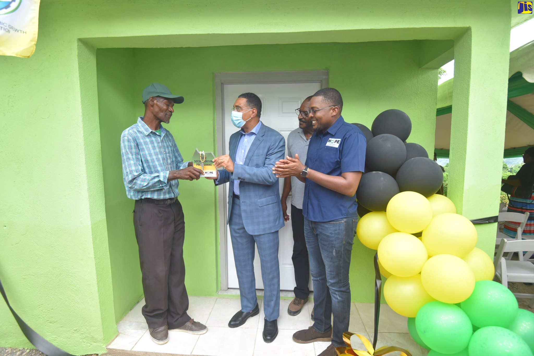Prime Minister, the Most Hon. Andrew Holness (second left), presents Albert Logan (left), with the keys to his new one-bedroom home during a hand over ceremony at Trout Hall Pass in the Clarendon North Central constituency on Wednesday (July 20). Also participating (from right) are Member of Parliament (MP) for Clarendon North Central and Minister without Portfolio in the Office of the Prime Minister with Responsibility for Information, Hon. Robert Morgan; and Councillor for the Chapelton Division in Clarendon,  Hershel Brown. The house was provided under the Government’s New Social Housing Programme (NSHP) which was developed to improve the housing condition of the country’s poor and disadvantaged population by providing quality, affordable and sustainable housing.  