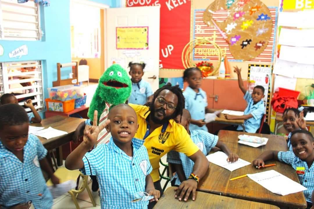 Author and Chief Executive Officer of Studio Dan, Danijah Taylor (centre), uses creative methods to engage young Jamaicans and encourage their interest in reading and writing. 

