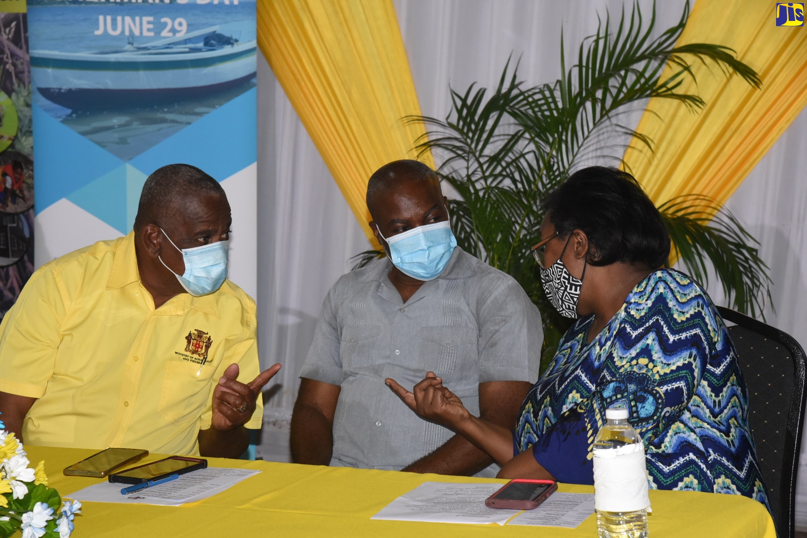 Permanent Secretary in the Ministry of Agriculture and Fisheries, Dermon Spence (centre), and State Minister, Hon. Franklin Witter (left), in discussion with Executive Director, Caribbean Coastal Area Management Foundation, Ingrid Parchment, at a recent International Fisherman’s Day Conference, at the Wembley Centre of Excellence, in Hayes, Clarendon. 