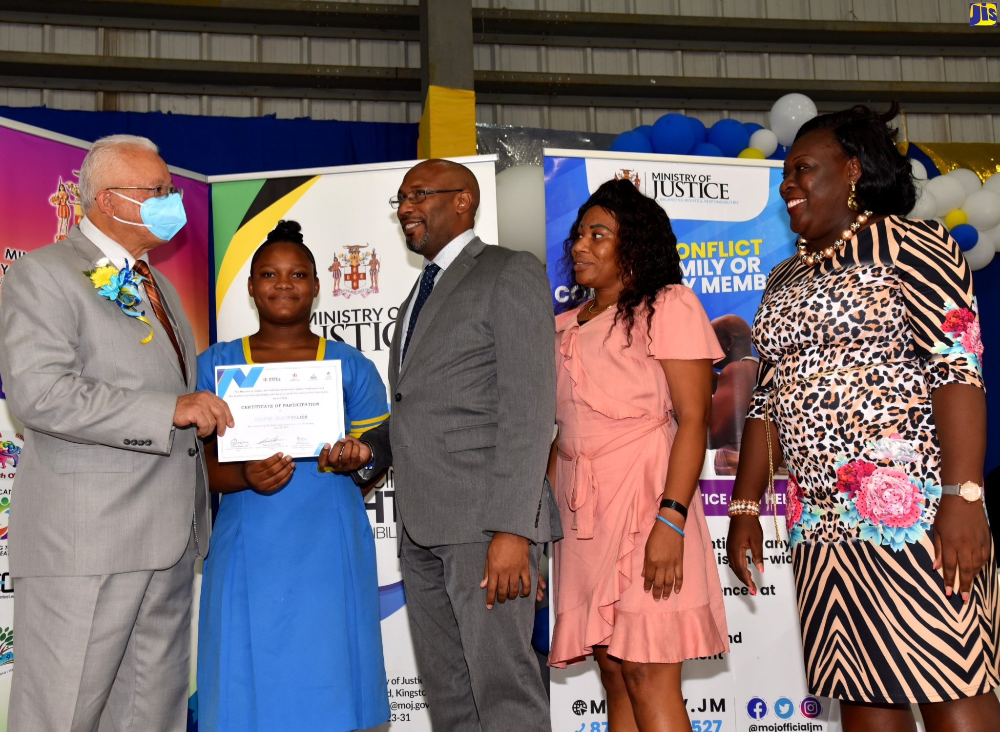 (From left) Minister of Justice, Hon. Delroy Chuck presents a certificate of participation in the Restorative Justice Workshop to representatives from Cambridge High School in St. James. They are student, Trisha-Gaye Wallace; Principal Harry Hanson; Parent, Nadia Brown and Dean of Discipline, Primrose Barnett. The award ceremony was held at the Jamaica College Auditorium in St. Andrew Friday (July 15).