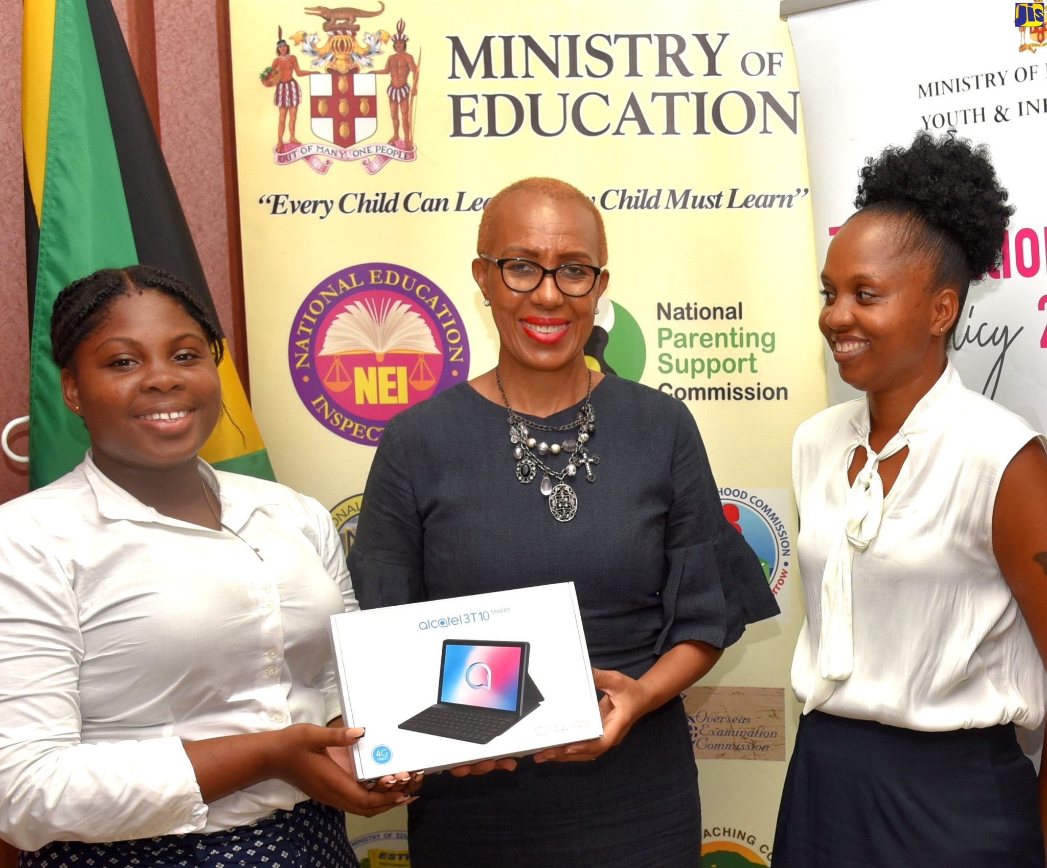 Minister of Education and Youth, Hon. Fayval Williams (centre), presents the 2021/22 Youth Policy Ambassador and winner of the National Youth Policy Creative Challenge, Samantha Blake (left), with her prize of a 4G Smart Tablet, during a recent presentation ceremony, held at the Ministry in Kingston. At right is Samantha’s Mother, Kimberly Daley.
