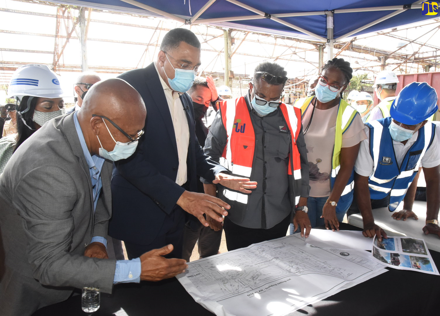Prime Minister, the Most Hon. Andrew Holness (second left) discusses plans for the Morant Bay Urban Centre project with, from left, Mayor of Morant Bay, Councillor Michael Hue; Architect, Bryan Morris; Kencasa Project Management group representative, Claire-Ann Kennedy; and Chairman of the Factories Corporation of Jamaica (FCJ), Lyttleton Shirley. The Prime Minister toured the site on Thursday (July 14) where he observed preparation work underway on the project.