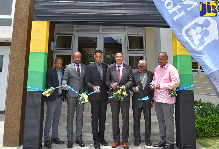 Prime Minister, the Most Hon. Andrew Holness (third right), officially opens phase one of the Ruthven Towers apartment complex in Kingston, which was developed by the National Housing Trust (NHT), on Wednesday (August 3). Also participating in the ribbon-cutting exercise (from left) are Mayor of Kingston, Senator Councillor Delroy Williams; NHT Chairman, Lennox Channer; Ruthven Towers homeowner, Kirk Frankson; NHT Senior General Manager, Donald Moore; and Member of Parliament for St. Andrew South Eastern, where Ruthven Towers is located, Julian Robinson.