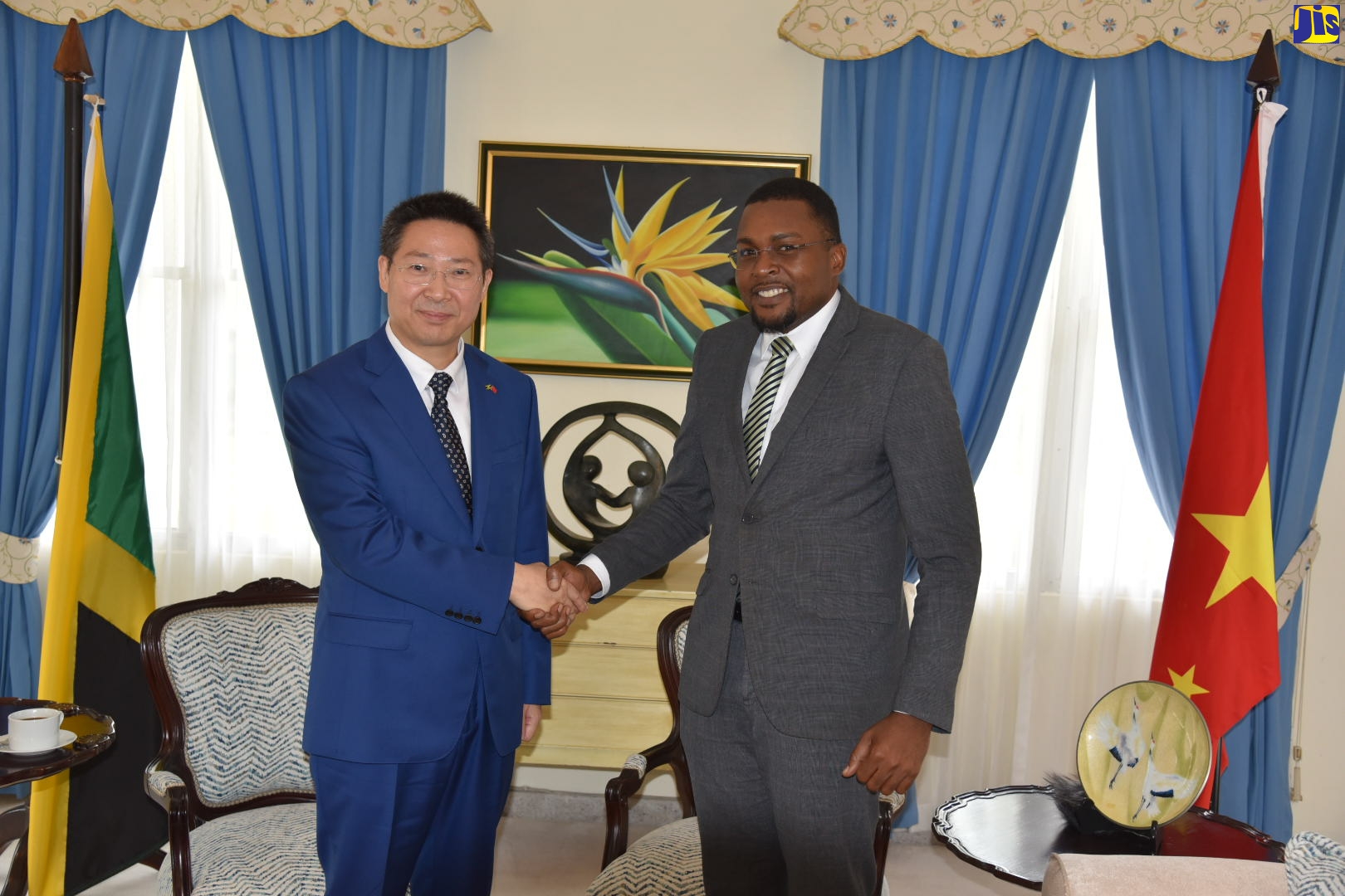 Minister without Portfolio in the Office of the Prime Minister with responsibility for Information, Hon. Robert Morgan (right), shakes hands with Ambassador of the People’s Republic of China to Jamaica, His Excellency Chen Daojiang, during a courtesy call at Jamaica House on Wednesday (August 3).