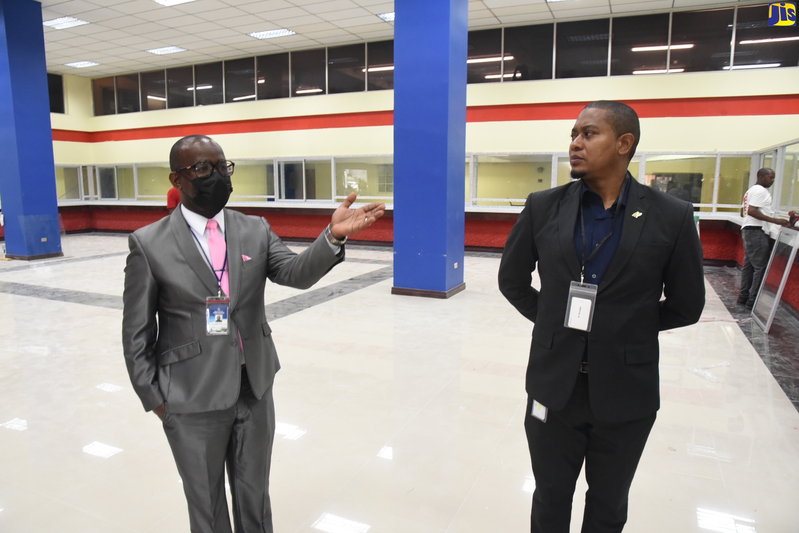 Minister without Portfolio in the Office of the Prime Minister, Hon. Floyd Green (right), listens to Programme Director of the National Identification System (NIDS), Dr. Warren Vernon, as he gives an overview of what will be the first pilot enrolment site, to be completed by the end of August. Minister Green participated in a tour of the facility at the Central Sorting Office on South Camp Road on Thursday (August 11).