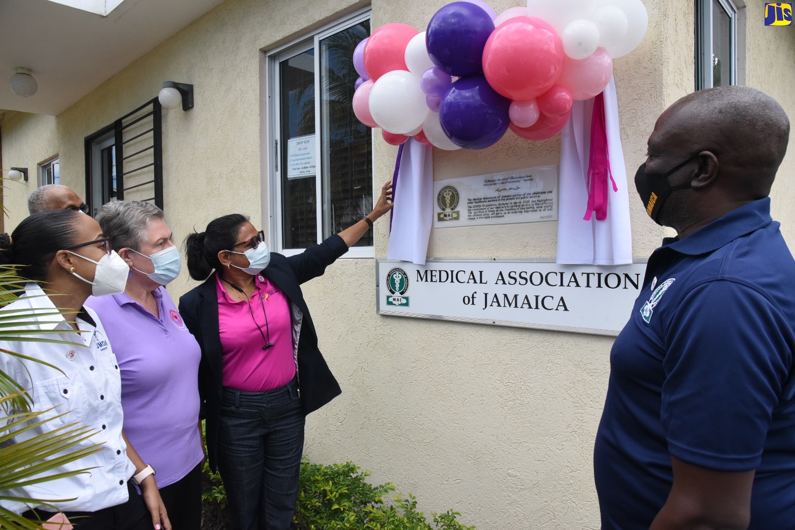Chief Medical Officer, Ministry of Health and Wellness, Dr. Jacquiline Bisasor-McKenzie (third left), officially unveils a commemorative plaque to honour front-line healthcare workers in the national COVID-19 pandemic response, which has been mounted at the Medical Association of Jamaica (MAJ) office on Windsor Avenue in Kinston, during a recent ceremony. Also participating in the event (from left) are Jamaica Medical Doctors Association (JMDA) President, Dr. Mindi Fitz Henley; Chair, Healthcare Workers Appreciation Month National Planning Committee, the Most Hon. Professor Denise Eldemire Shearer; and MAJ President, Dr. Brian James.