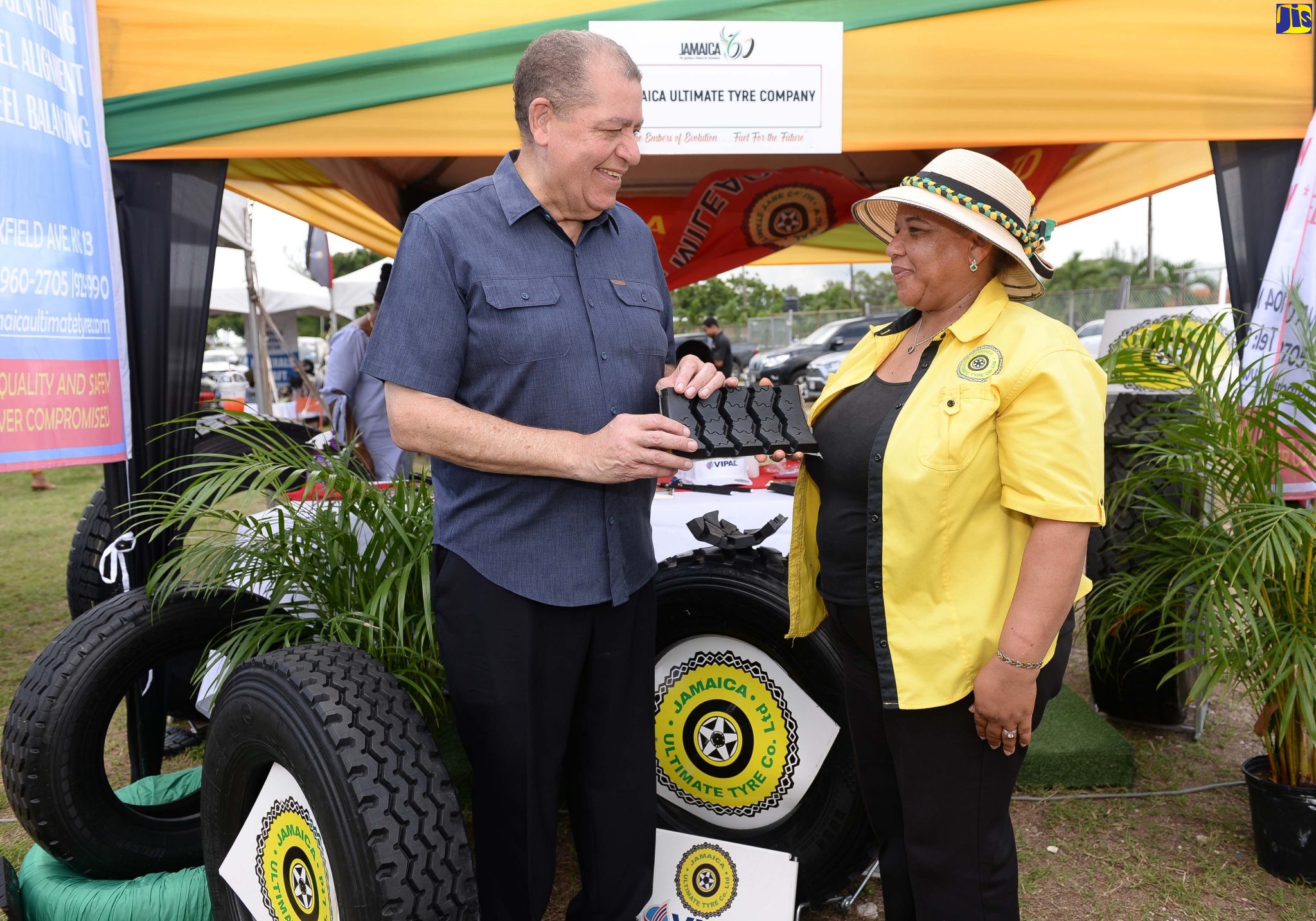 Minister of Transport and Mining, Hon. Audley Shaw, is being shown a piece of tyre by Sales and Marketing Officer at Jamaica Ultimate Tyre Company, Beverly Solomon. Occasion was the Ministry’s Jamaica 60 Expo at the Police Officers Club in St. Andrew on Friday (July 29), under the theme ‘The Embers of Evolution…Fuel for the Future’.