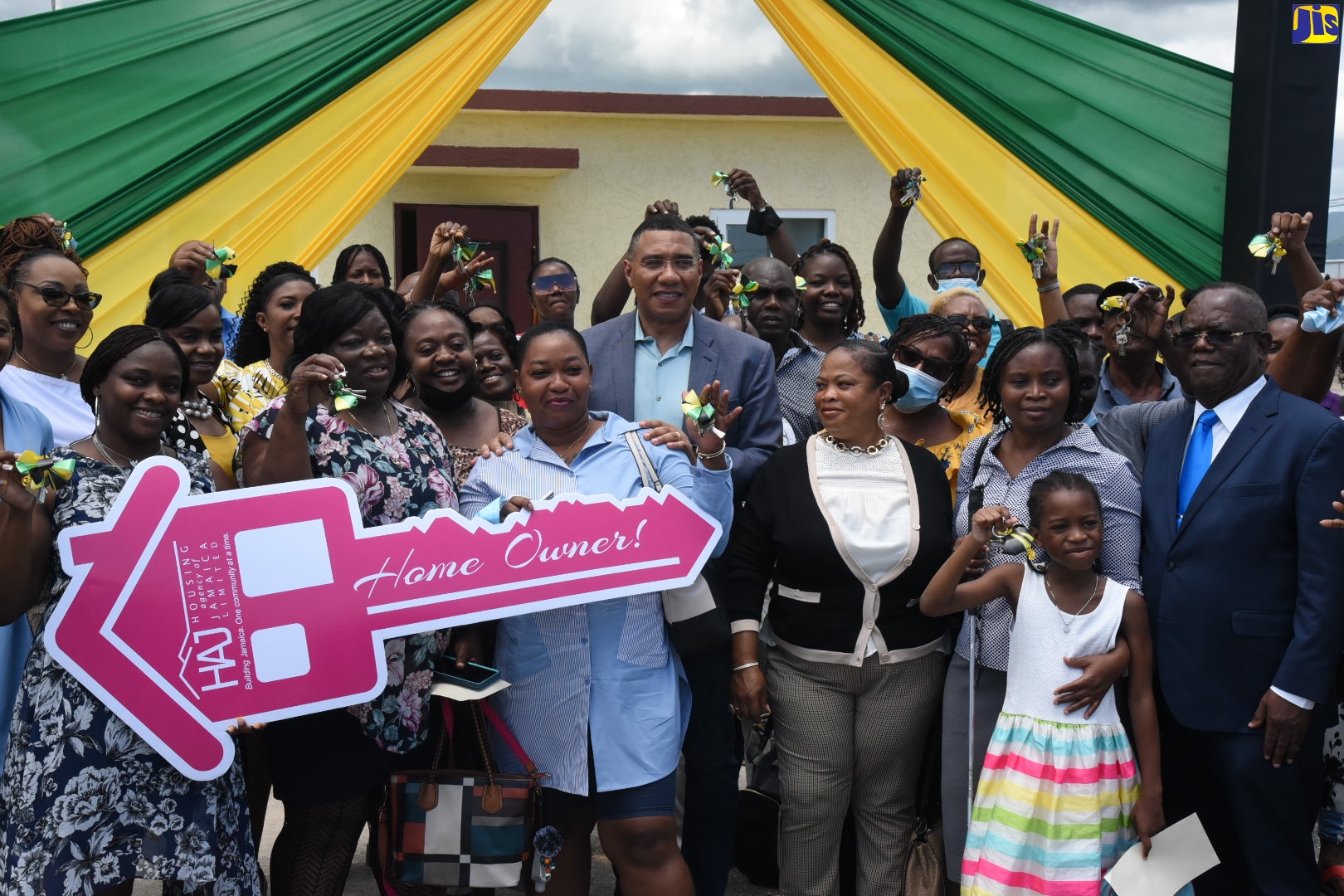 Prime Minister, the Most Hon. Andrew Holness (centre), with beneficiaries of the $14.7 billion Catherine Estates housing development in Dunbeholden, St. Catherine, on Friday (August 26).