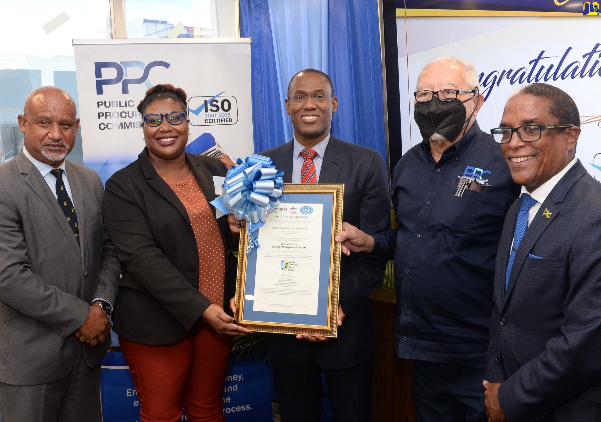 Minister of Finance and the Public Service, Dr. the Hon. Nigel Clarke (centre), holds the ISO 9001:2015 certificate that was presented to the Public Procurement Commission (PPC) by the National Certification Body of Jamaica (NCBJ) during a ceremony at the PPC in Kingston on Wednesday (August 24). With him are (from left) PPC’s Executive Director Lieutenant Commander (Ret’d,) Paul Wright; Manager, NCBJ, Navenia Wellington-Ford; Chairman of PPC, Raymond McIntyre and State Minister in the Ministry of Industry, Investment and Commerce, Dr. the Hon. Norman Dunn.