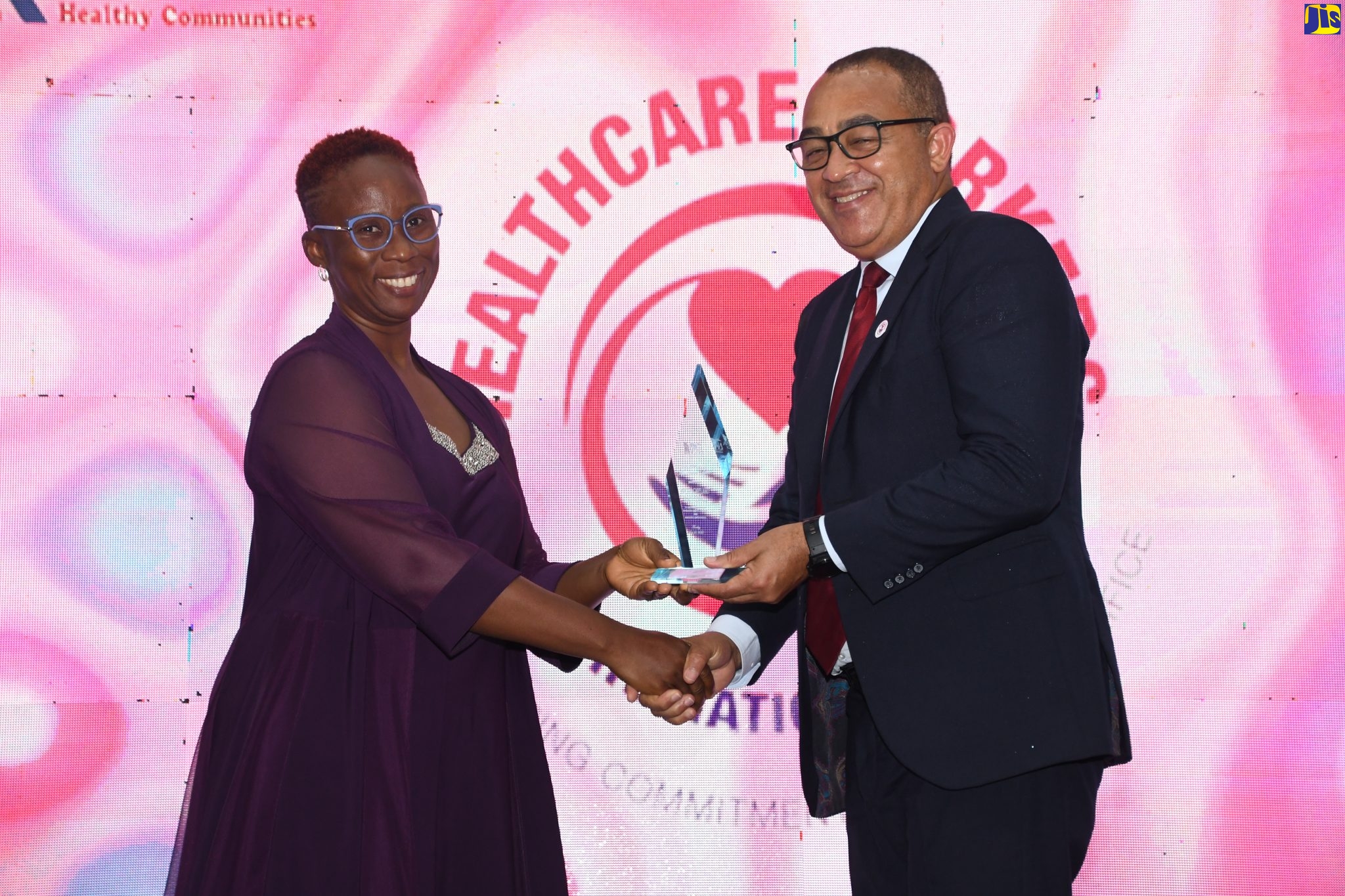 Minister of Health and Wellness, Dr. the Hon. Christopher Tufton (right), presents an appreciation plaque to Parish Manager at Westmoreland Public Health Services, Novlin Leslie Little, during the Western Regional Health Authority’s (WRHA) COVID-19 Recognition Gala, which was held at the Montego Bay Convention Centre in St. James on Thursday (July 28).