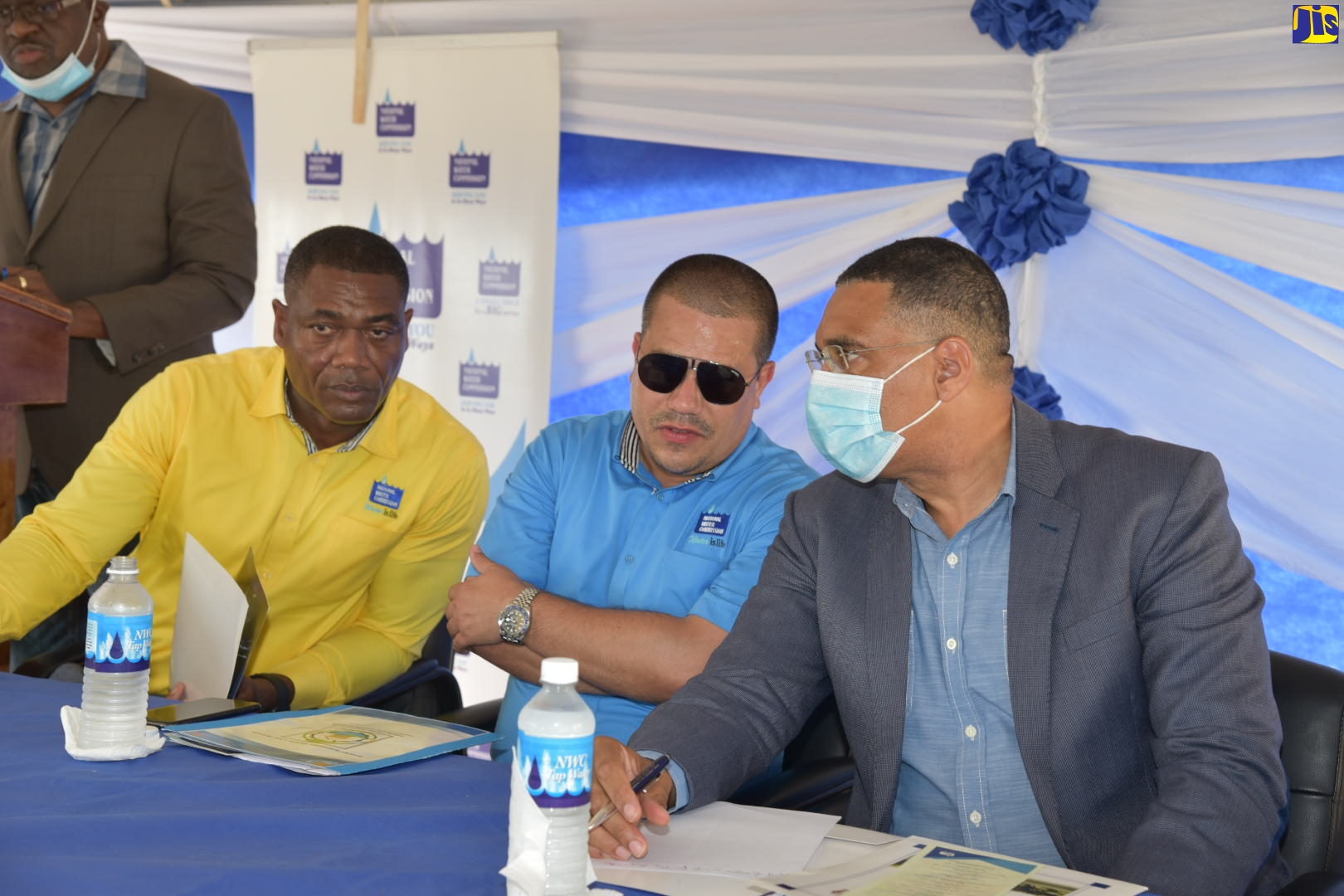 Prime Minister, the Most Hon Andrew Holness (right) converses with Minister without portfolio in the Ministry of Economic Growth and Job Creation, Senator the Hon Matthew Samuda (centre) and National Water Commission (NWC) President, Mark Barnett (left) during a ceremony to commission into service the $129 million Sandy Ground to Black River Replacement Pipeline in St. Elizabeth, on Friday, July 29.