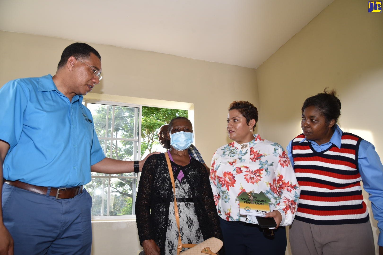 Prime Minister, the Most Hon. Andrew Holness (left), congratulates Elfreda Randan, during a tour of her new one bedroom house in Clay Ground District in Bamboo, St. Ann, on Friday (August 19). Looking on are Member of Parliament for St. Ann North Western, Krystal Lee (second right), and Chair of the New Social Housing Programme (NSHP) Oversight Committee, Judith Robb-Walters.