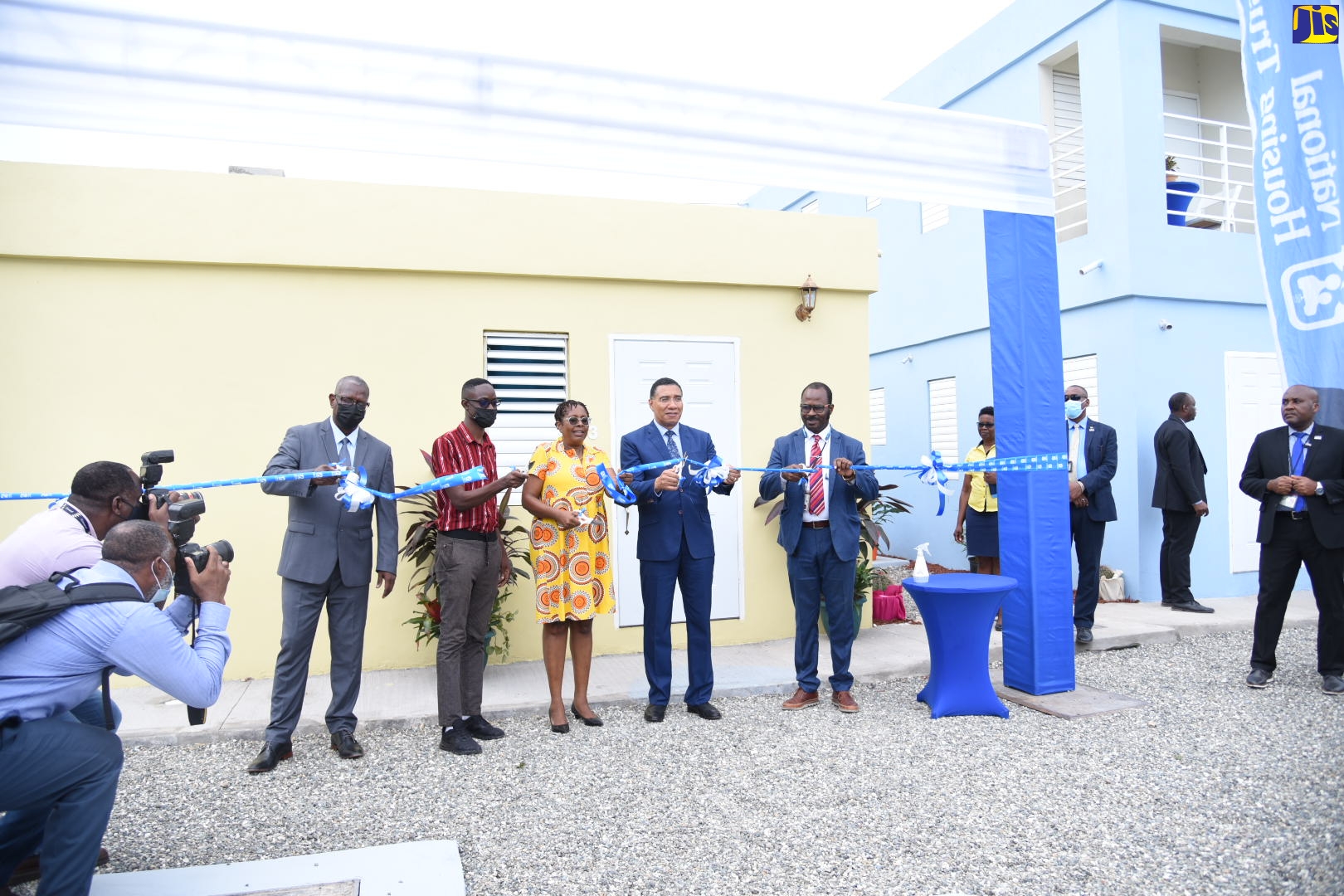 Prime Minister, the Most Hon. Andrew Holness (fourth left), cuts the ribbon to a unit of the newly constructed Majesty Gardens phase 1A, in St. Andrew. Assisting in the exercise are (from left) Managing Director, National Housing Trust (NHT), Martin Miller; new homeowner, Reginald Henclewood; Member of Parliament, St. Andrew South Western, Dr. Angela Brown-Burke; and Board Director, NHT, Corporal Rohan James. Thirty-two duplex housing units were handed over to proud new homeowners under the National Housing Trust (NHT) Community Renewal Programme (CRP). The ceremony was held on Wednesday (August 24) on the site of the new housing complex.  