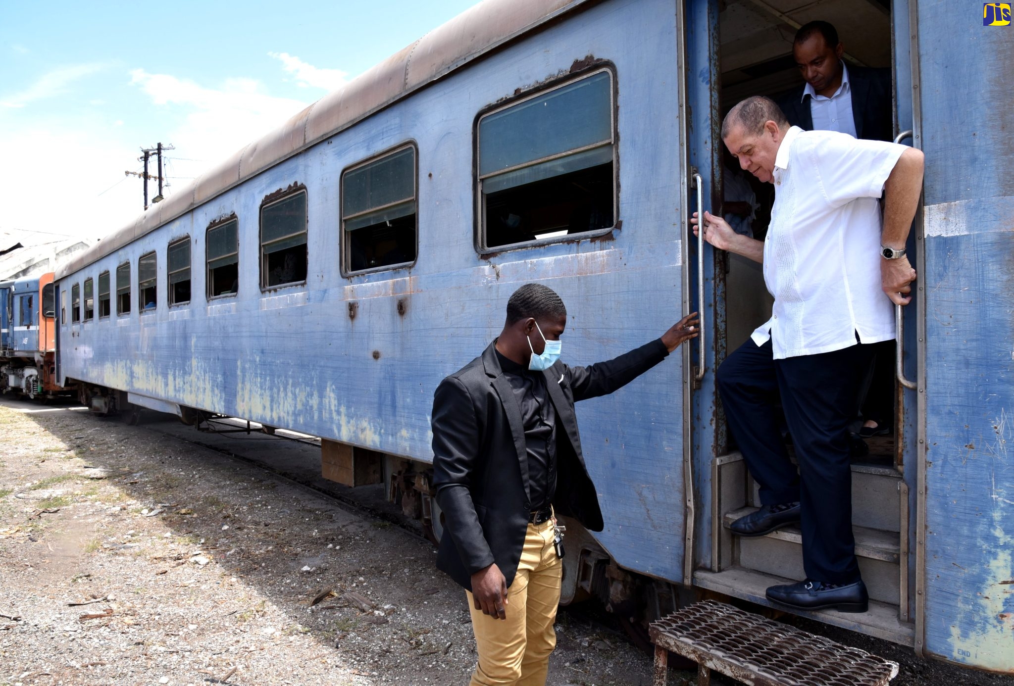 Minister of Transport and Mining, Hon. Audley Shaw (centre), disembarks a train during a recent tour of the Jamaica Railway Corporation (JRC) terminus in West Kingston. 
                                                                                                                               
