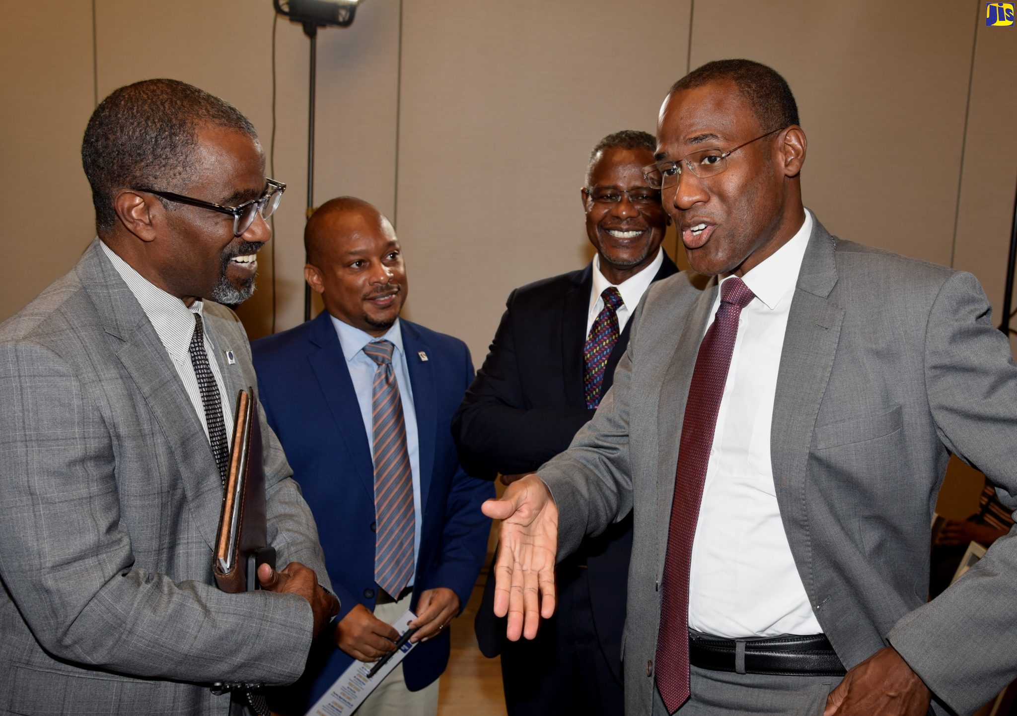 Minister of Finance and the Public Service, Dr. the Hon. Nigel Clarke (right), converses with Development Bank of Jamaica (DBJ) Managing Director, Anthony Shaw (left), during Thursday’s (August 11) launch of the entity’s Entertainment and Transport Sector Loan products, at the AC Marriott Kingston Hotel. Sharing in the discussion are General Manager for DBJ’s Channels, Relationship and Marketing Division, Edison Galbraith (second left); and DBJ Manager for Investor Relations, Paul Chin.   