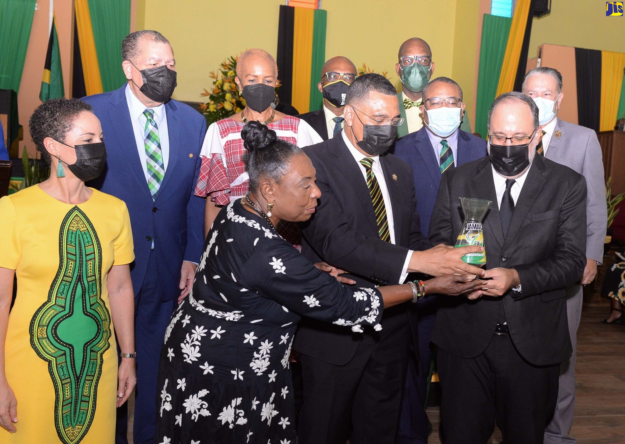 Prime Minister, the Most Hon. Andrew Holness (front row, centre); Leader of the Opposition, Mark Golding (front row, right); and Minister of Culture, Gender, Entertainment and Sport, Hon. Olivia Grange (front row, left), hold a vase bearing sand depicting the colours of the national flag during the National Independence and Emancipation Day Church Service at the Boulevard Baptist Church, 2 Washington Boulevard, Kingston 20 on July 31. Others observing (from left) are: Minister of Foreign Affairs and Foreign Trade, Senator Hon. Kamina Johnson Smith; Minister of Transport and Mining, Hon. Audley Shaw; Minister of Education and Youth, Hon. Fayval Williams; Minister of  State in the Ministry of Foreign Affairs and Foreign Trade, Senator Leslie Campbell; Member of Parliament for St. Catherine South Eastern, Robert Miller; Member of Parliament, Western St. Andrew, Anthony Hylton; and President of the Senate, Tom Tavares Finson.