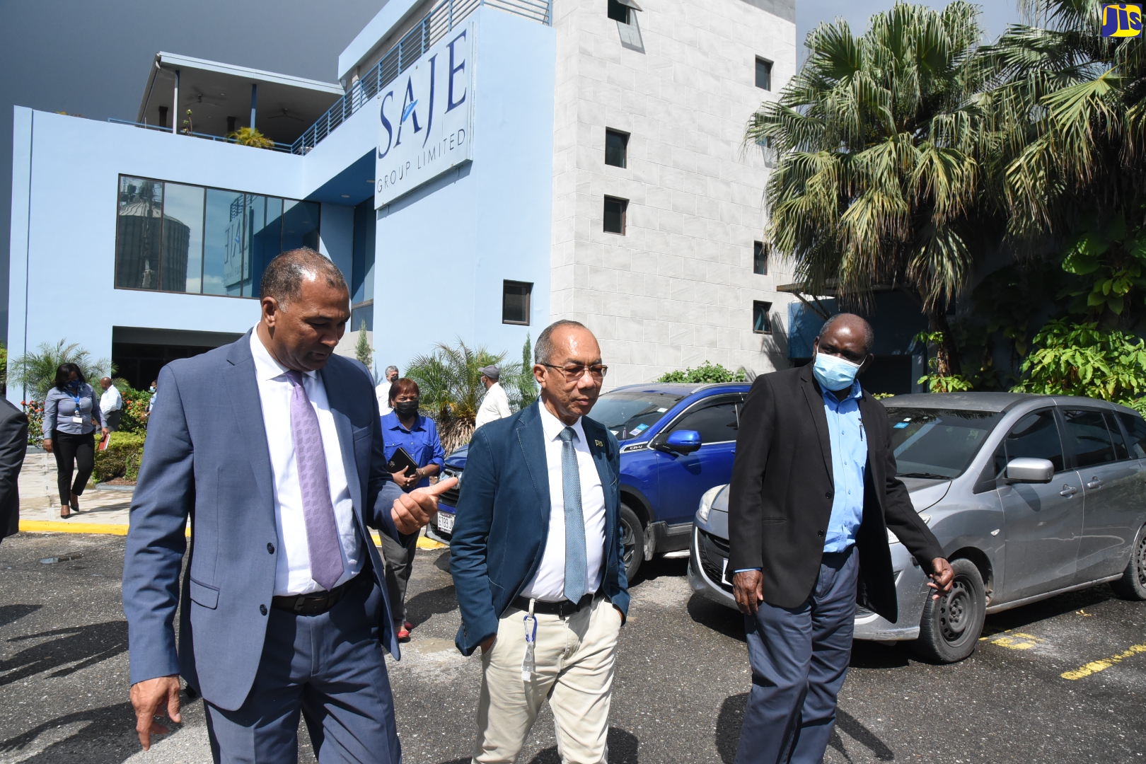 Minister of National Security, Hon. Dr. Horace Chang (centre), along with President of the Shipping Association of Jamaica (SAJ), William Brown (left), and Permanent Secretary in the Ministry, Courtney Williams (right), tours a section of the Newport business community in Kingston, on Tuesday (August 23).