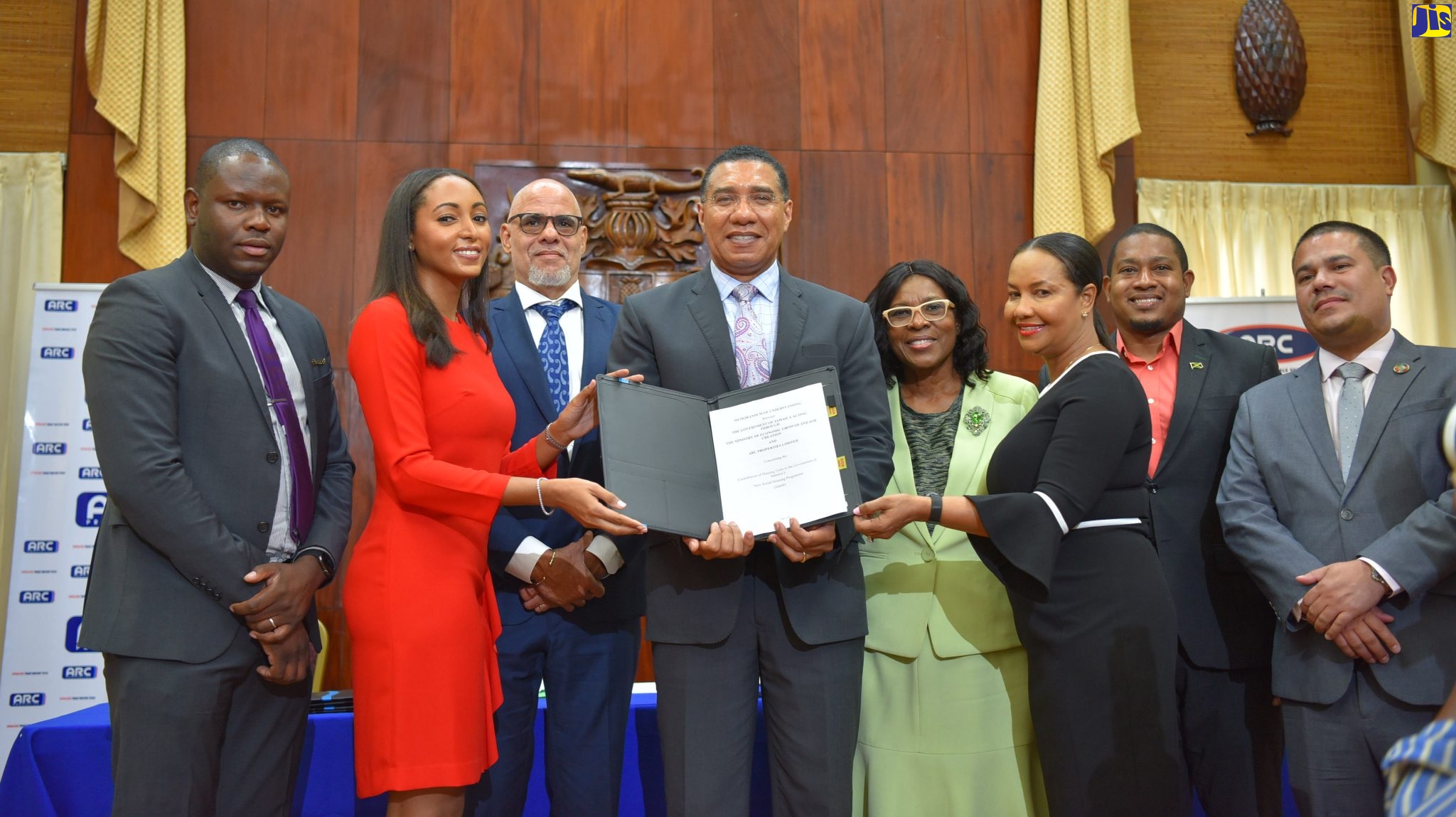 Prime Minister the Most Hon. Andrew Holness (fourth left), and Managing Director, Arc Properties Limited, Ashley-Ann Horne (second left), display the Memorandum of Understanding (MoU) signed on Tuesday (August 23) between the Ministry of Economic Growth and Job Creation and Arc Properties Limited, for the contribution of units to the New Social Housing Programme. Others (from left) are: Managing Director, Kinetic Engineering Services, Keon Hinds; President, Private Sector Organisation of Jamaica, Keith Duncan; Permanent Secretary in both the Office of the Prime Minister and the Ministry of Economic Growth and Job Creation, Audrey Sewell; Director of Arc Properties and Deputy Chair of Arc Manufacturing, Charlotte Horne Hayles; Minister without Portfolio in the Office of the Prime Minister, Hon. Floyd Green, and Minister without Portfolio in the Ministry of Economic Growth and Job Creation, Senator the Hon. Matthew Samuda.

