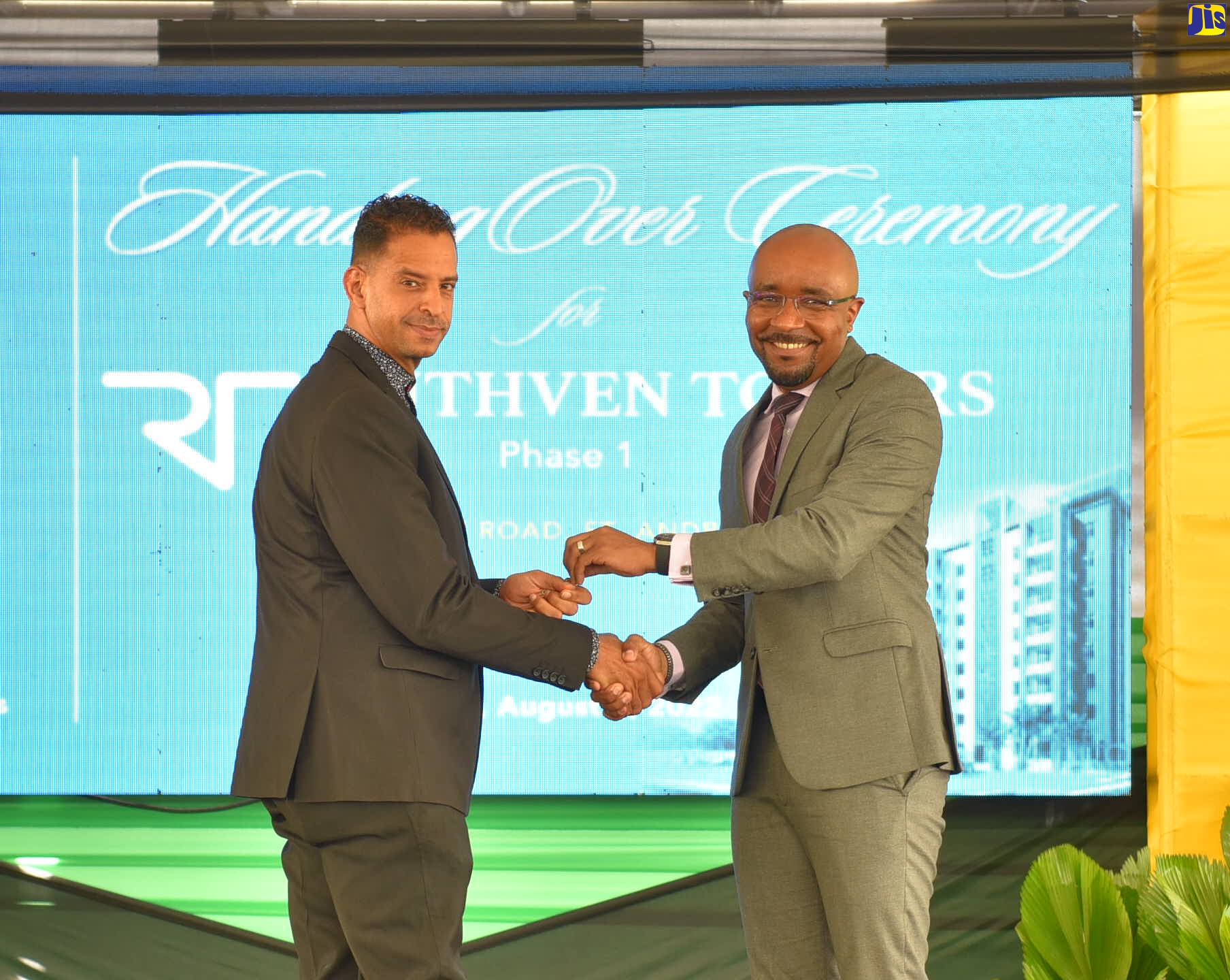 National Housing Trust (NHT) Chairman, Lennox Channer (right), presents new Ruthven Towers homeowner, Kirk Frankson, with the keys to his apartment, during the official opening of the complex, situated at 1-3 Ruthven Road in Kingston on August 3. Ruthven Towers was developed by the NHT.