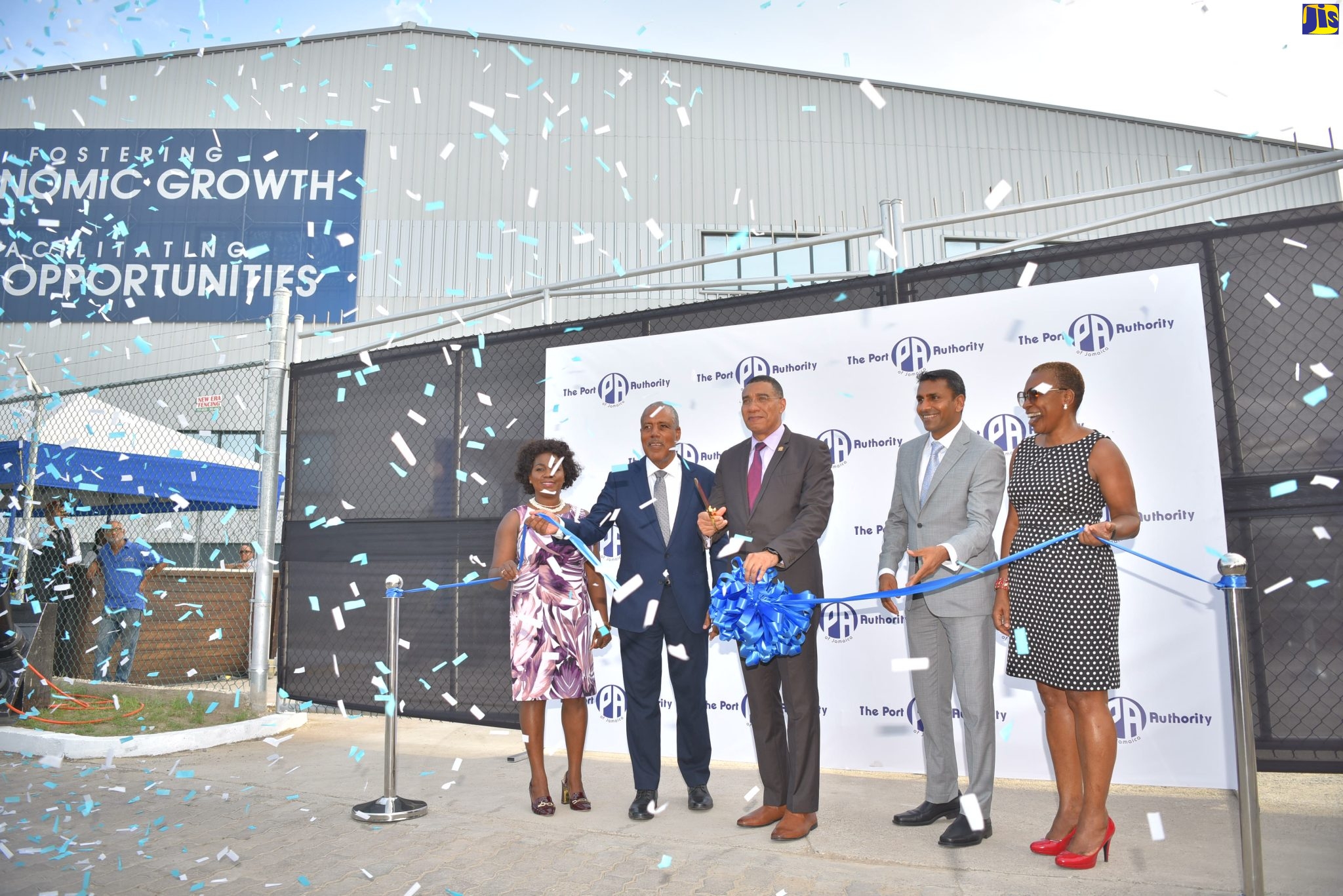 Prime Minister, the Most Hon. Andrew Holness (centre), cuts the ribbon to open the Kingston Logistics Park (KLP) on Wednesday (August 3). Participating in the ribbon-cutting exercise (from left) are Vice President, Business Process Outsourcing (BPO) and Logistics, Port Authority of Jamaica (PAJ), Gloria Henry; President and Chief Executive Officer, PAJ, Professor Gordon Shirley; Chairman, PAJ, Alok Jain; and Senior Vice President for Finance, Information Technology, Corporate Strategy and Procurement, PAJ, Elva Williams-Richards.