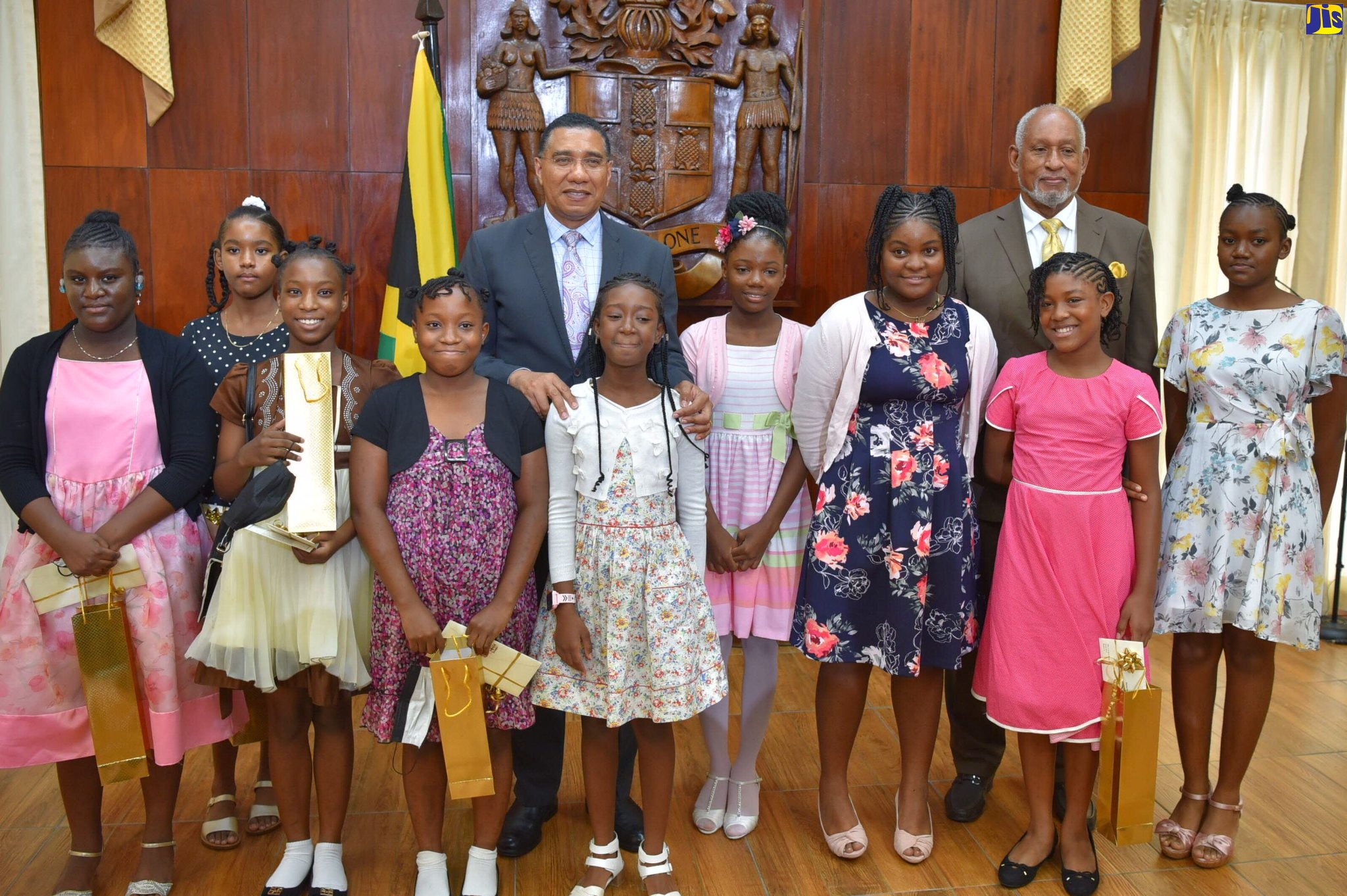 Prime Minister, the Most Hon. Andrew Holness (fifth left) and Cabinet Secretary, Ambassador Douglas Saunders (second right, background), are pictured with Primary Exit Profile (PEP) awardees following a presentation ceremony at Banquet Hall, Jamaica House, on Tuesday (August 23).