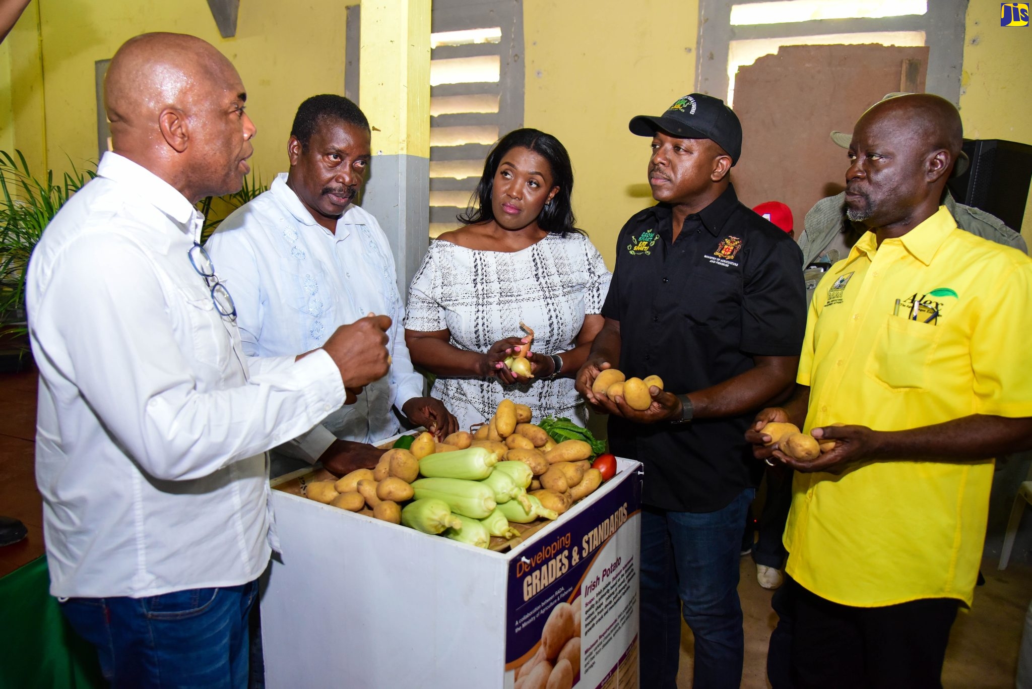 Minister of Agriculture and Fisheries, Hon. Pearnel Charles Jr. (second right), displays potatoes from this year’s crop as he listens to a point being made by Coordinator of the National Irish Potato and Onion Programme, Locksley Waites (left). Occasion was the launch of the 2022 National Irish Potato and Onion Programme in Guy’s Hill, St. Catherine, on August 31. Also pictured are (from left) Member of Parliament, St. Mary Western, Robert Montague; Member of Parliament for St. Catherine North East, Kerensia Morrison; and Acting Chief Executive Officer, Rural Agricultural Development Authority (RADA), Winston Simpson.