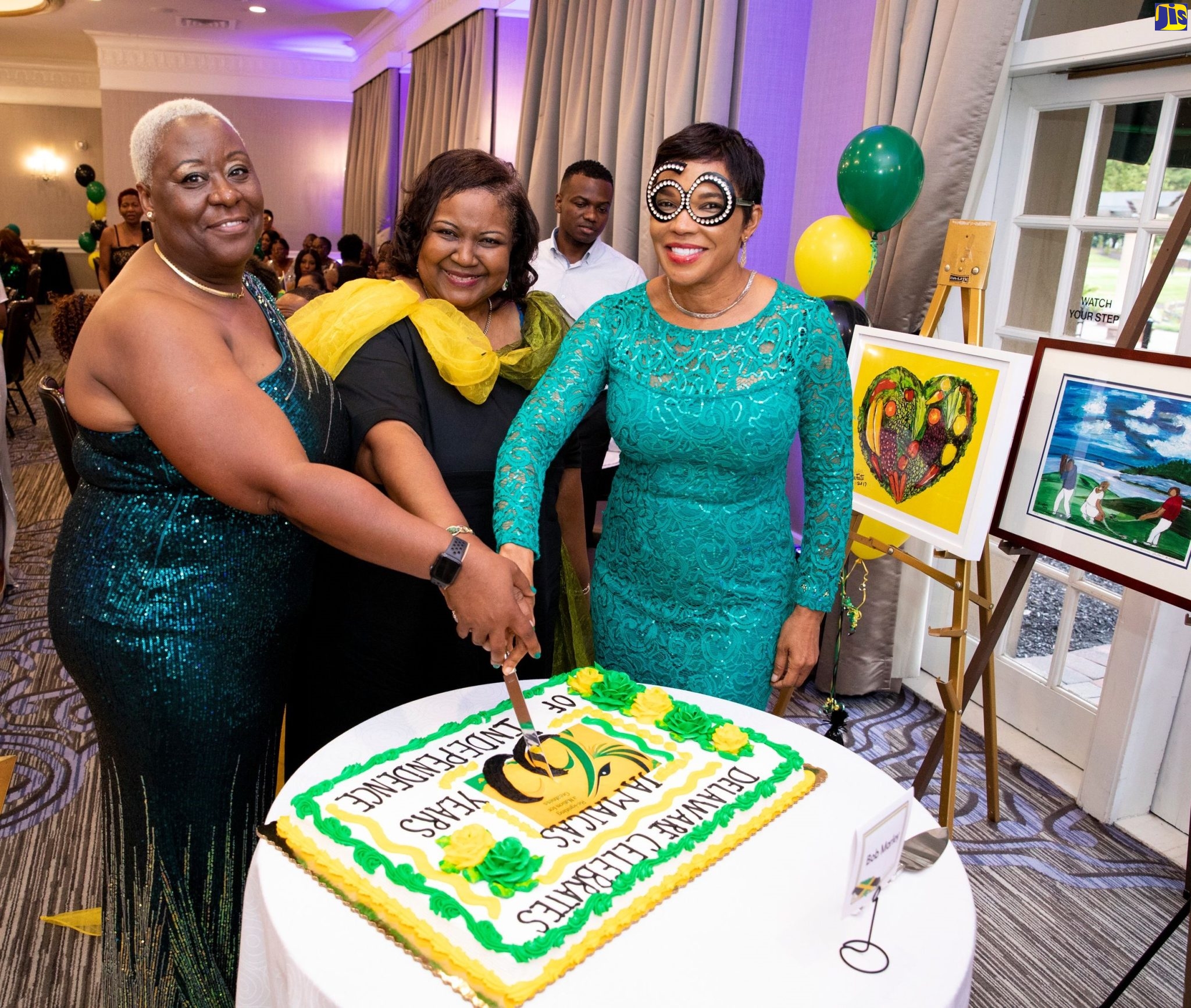 Jamaica’s Ambassador to the United States, Her Excellency Audrey Marks (right), is joined by Rosemarie McDonald and Commissioner Lorraine Bradley, in cutting a cake to commemorate Jamaica’s 60th anniversary of independence. The occasion was a dinner hosted by members of the Jamaican Diaspora in Delaware at the Hilton Willington Hotel on August 28.