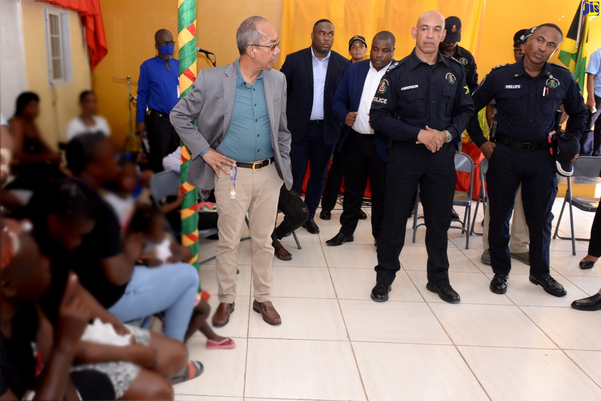 Minister of National Security, Hon. Dr. Horace Chang (left); Commissioner of Police, Major General Antony Anderson (second left), and Head of the South St. Catherine Police Division, Senior Superintendent (SSP) Christopher Phillips (right), in a meeting with residents of Spring Village,  St. Catherine, recently. They also met with grieving families, following a gun attack that killed three persons and injured several others at a football match in the community.