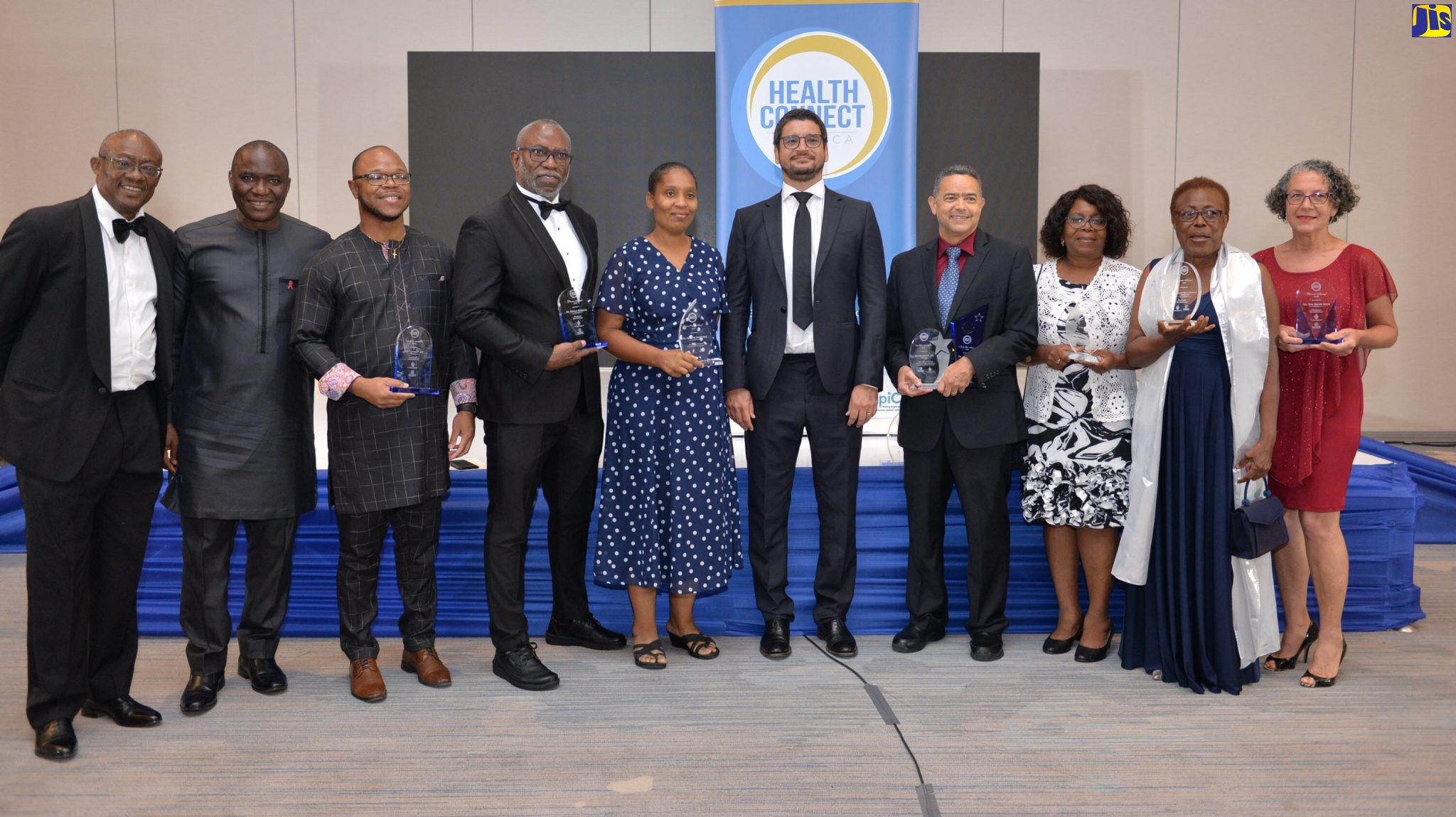 Regional Director for the United Nations Programme on HIV/AIDS (UNAIDS), Dr. Richard N. Amenyah (second left), and Director of Health Connect Jamaica (HCJ), Geoffrey Barrow (fifth right), share a moment with key stakeholders at the HCJ’s inaugural dinner and awards banquet held recently at the AC Marriott Hotel in New Kingston.